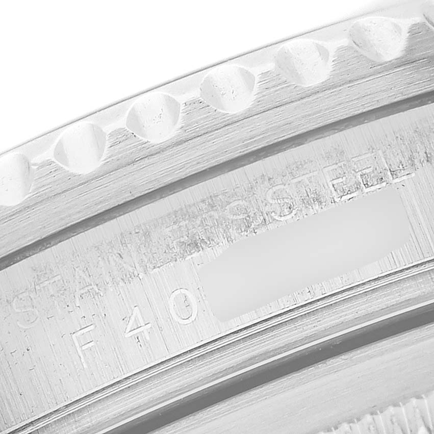 The image shows a close-up of the engraved details on the stainless steel bezel or case back of a Rolex GMT-Master M16710LN Men
s Stainless Steel Black Dial M16710LN Men
s Stainless Steel Black Dial watch.