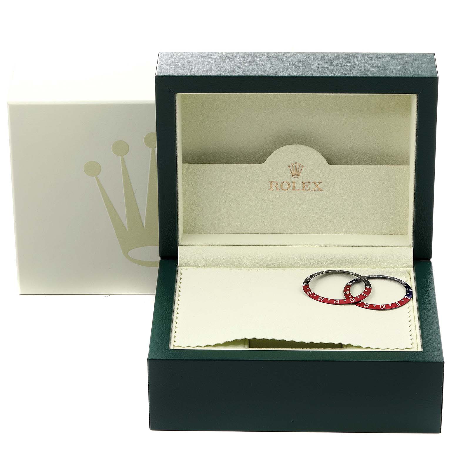 The image shows a Rolex GMT-Master 16710 Men
s Stainless Steel Black Dial 16710 Men
s Stainless Steel Black Dial watch box with two bezel inserts placed on a cloth inside.