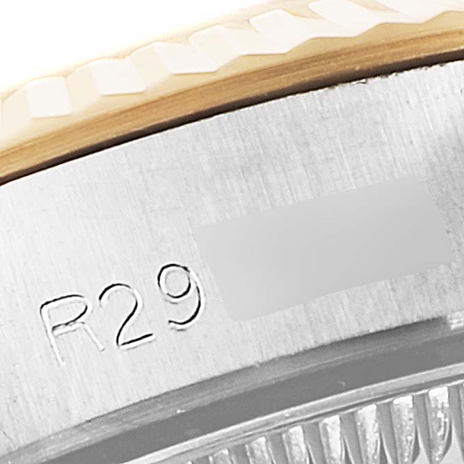 This image shows a close-up of the serial number engraving on the case side of a Rolex Oyster Perpetual 67193 Women
s Steel and Gold (two tone) Champagne Dial 67193 Women
s Steel and Gold (two tone) Champagne Dial watch.