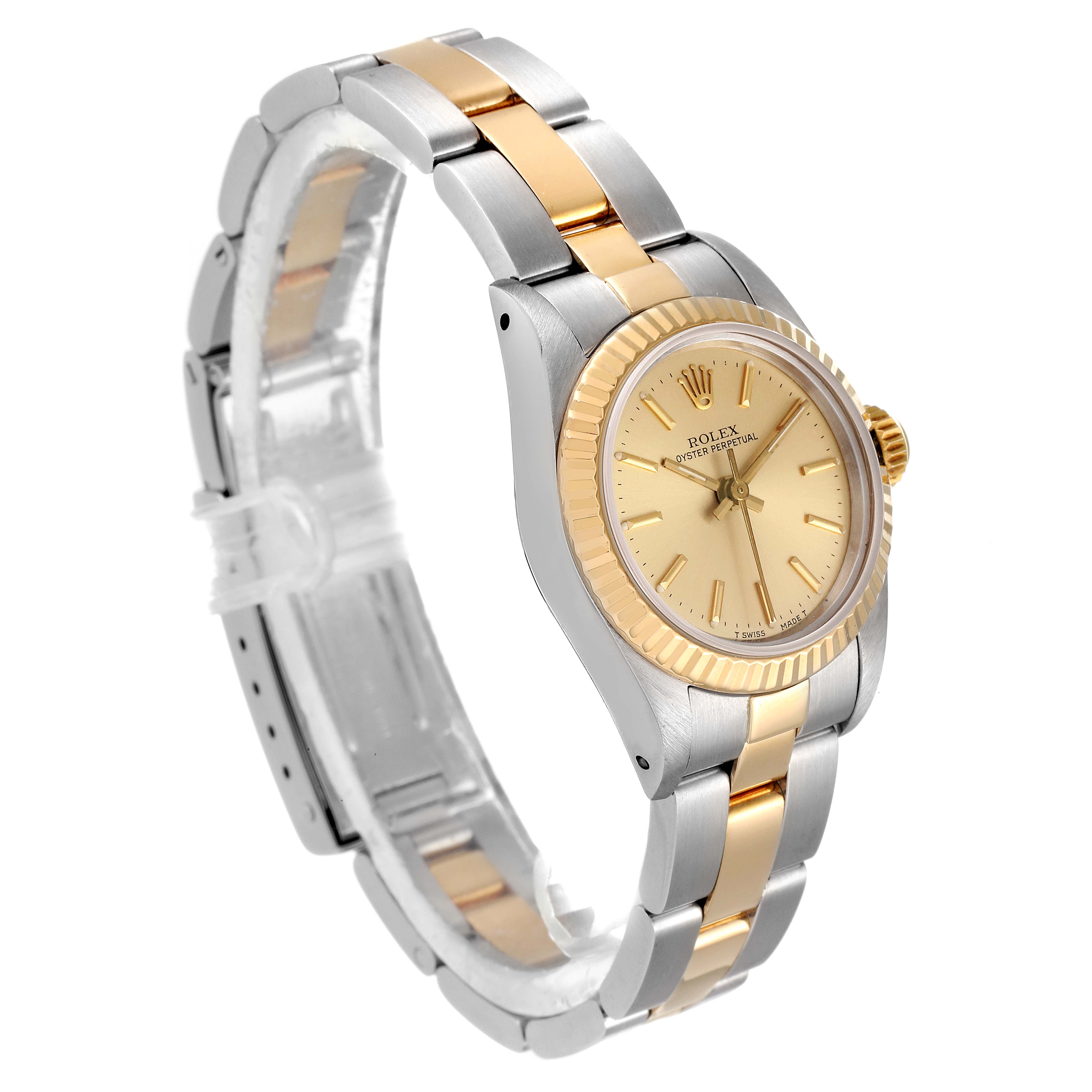 The Rolex Oyster Perpetual 67193 Women
s Steel and Gold (two tone) Champagne Dial 67193 Women
s Steel and Gold (two tone) Champagne Dial watch is shown from a front-side angle, highlighting its two-tone bracelet and champagne dial.