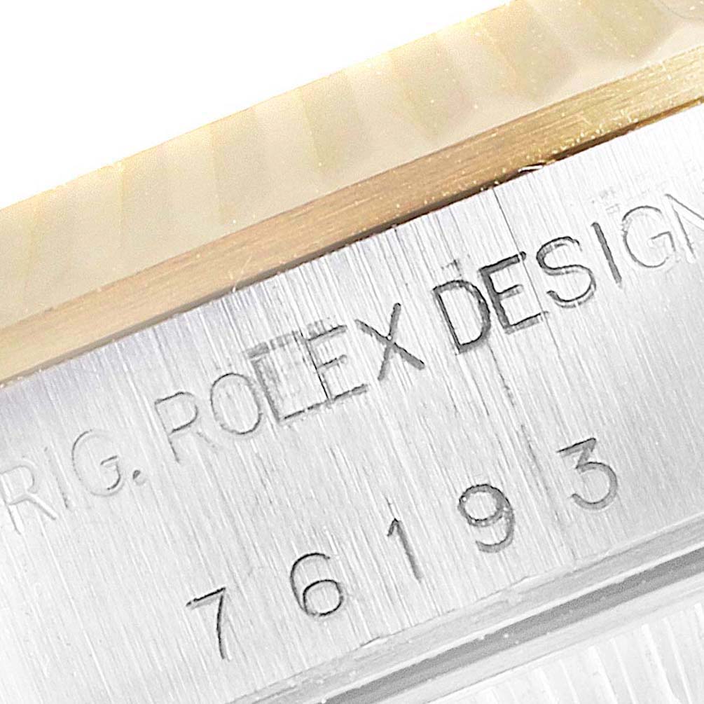 The image shows a close-up of the engraving on the side of a Rolex Oyster Perpetual 76193 Women
s Steel and Gold (two tone) Champagne Dial 76193 Women
s Steel and Gold (two tone) Champagne Dial watch case, displaying the model number "76193."