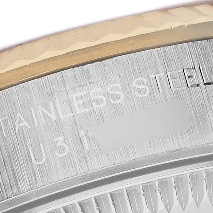 The image shows a close-up of the side bezel and engraved text on a Rolex Oyster Perpetual 67193 Women's Steel and Gold (two tone) Champagne Dial 67193 Women's Steel and Gold (two tone) Champagne Dial watch, highlighting the stainless steel part.