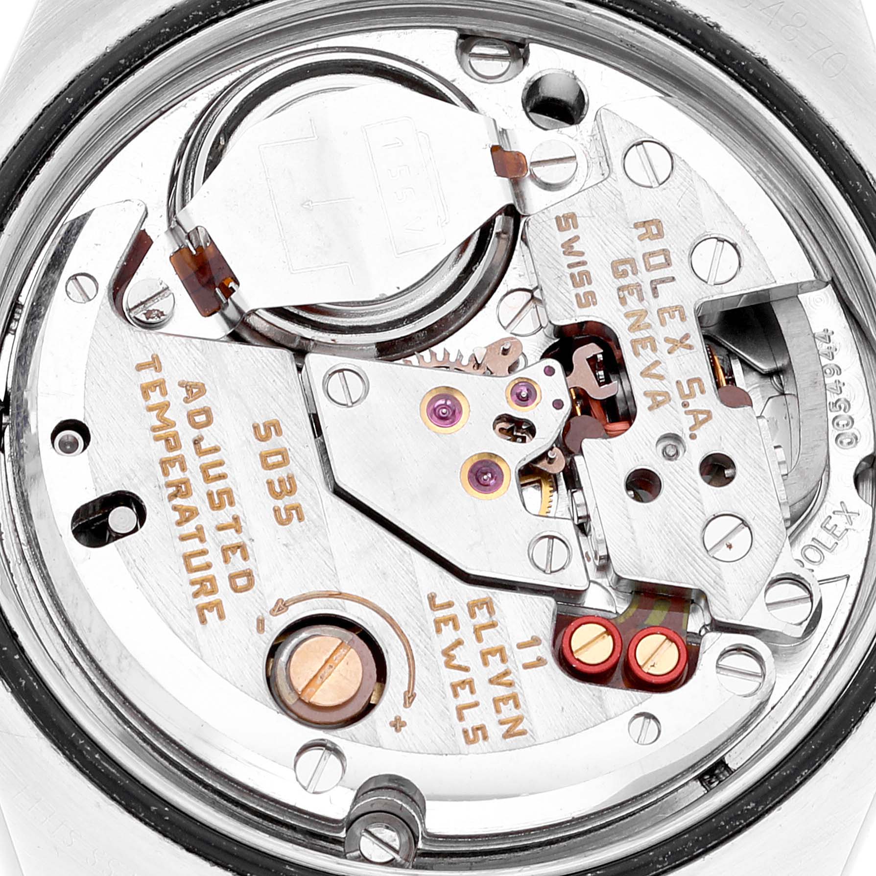 The image shows a close-up view of the internal movement components of a Rolex Oysterquartz 17014 Men's Stainless Steel Black Dial 17014 Men's Stainless Steel Black Dial watch, highlighting gears and engravings.