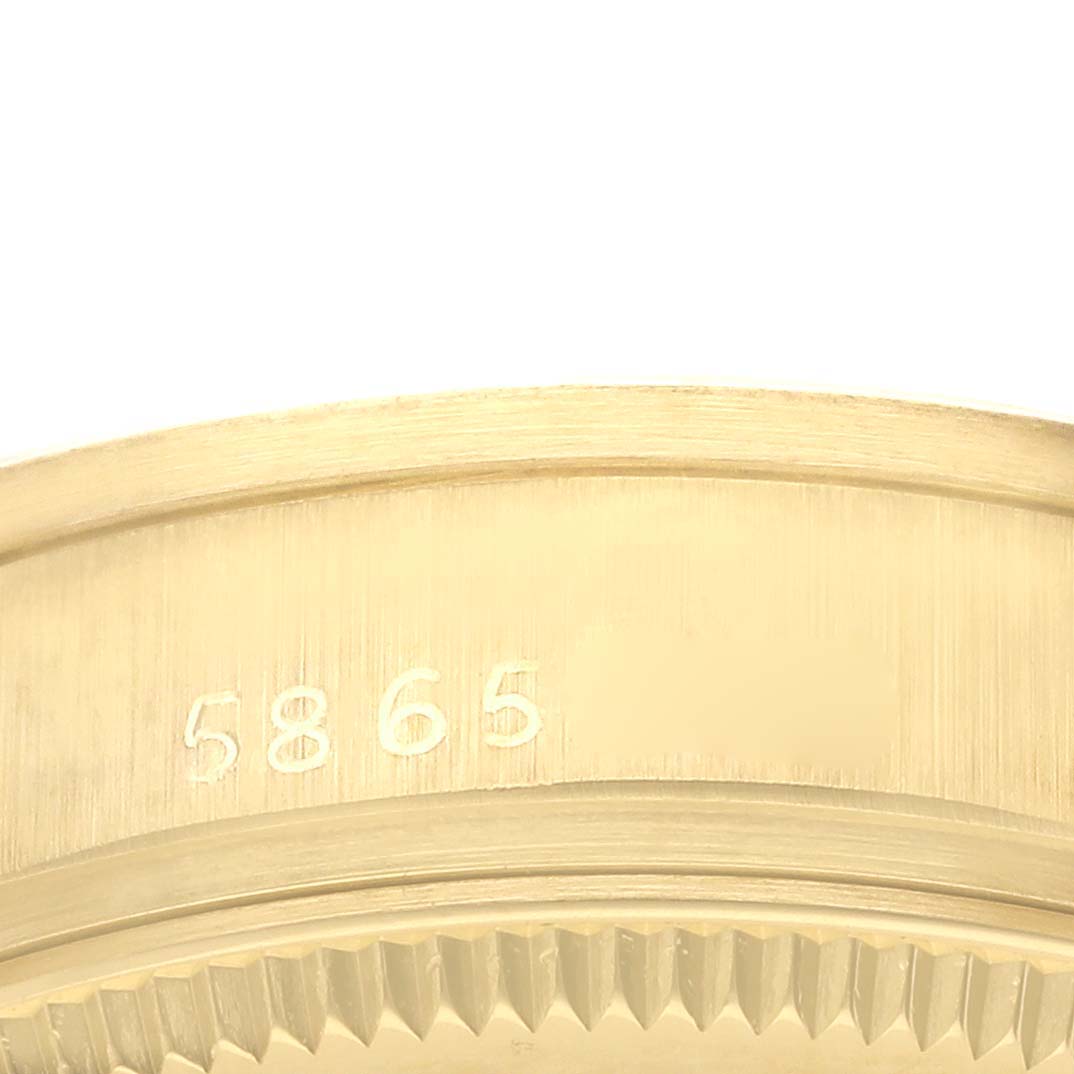 The image shows a close-up detail of the bezel and edge of the Rolex President 6824 Women's Yellow Gold White Dial 6824 Women's Yellow Gold White Dial model, featuring engravings and a textured finish.