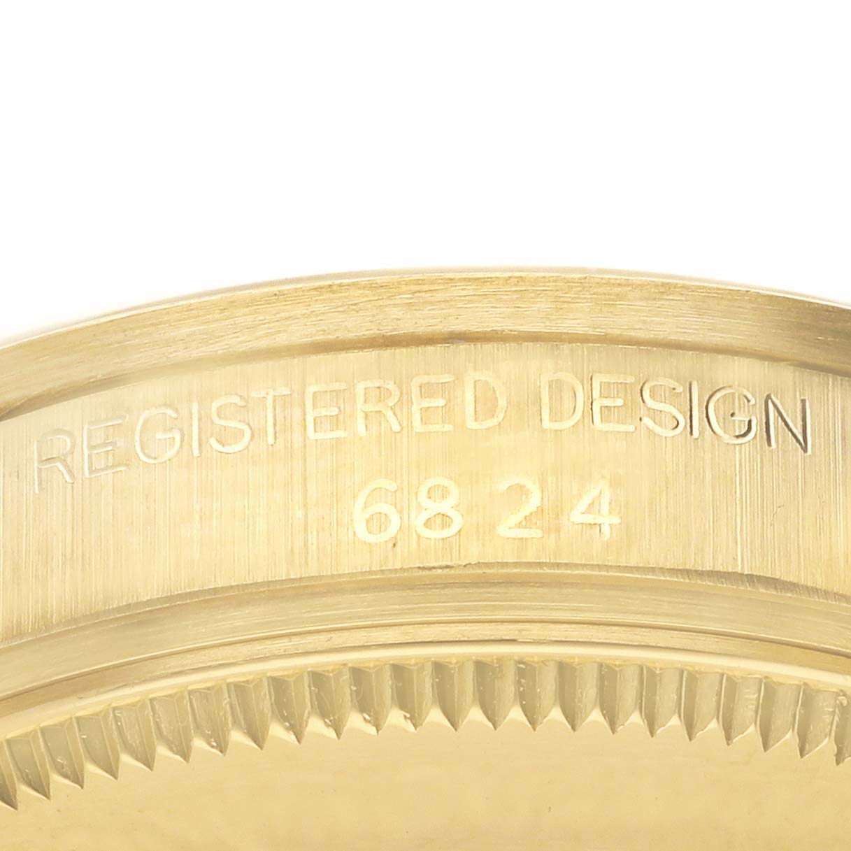 The image shows a close-up of the engraved bezel edge of a Rolex President 6824 Women's Yellow Gold White Dial 6824 Women's Yellow Gold White Dial watch, highlighting the design number.