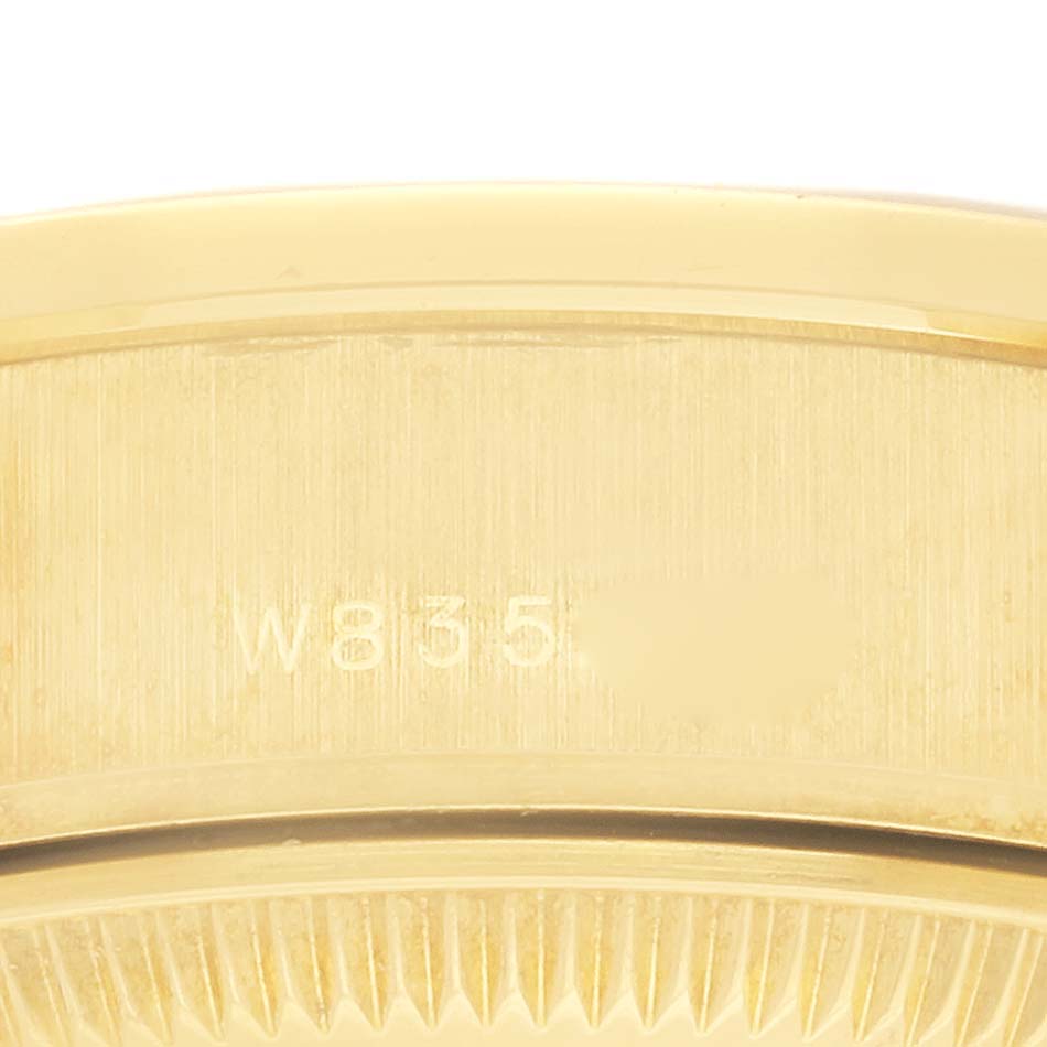 The image shows a close-up of the Rolex President 69138 Women's Yellow Gold Champagne Dial 69138 Women's Yellow Gold Champagne Dial model with focus on the edge and part of the scalloped bezel.