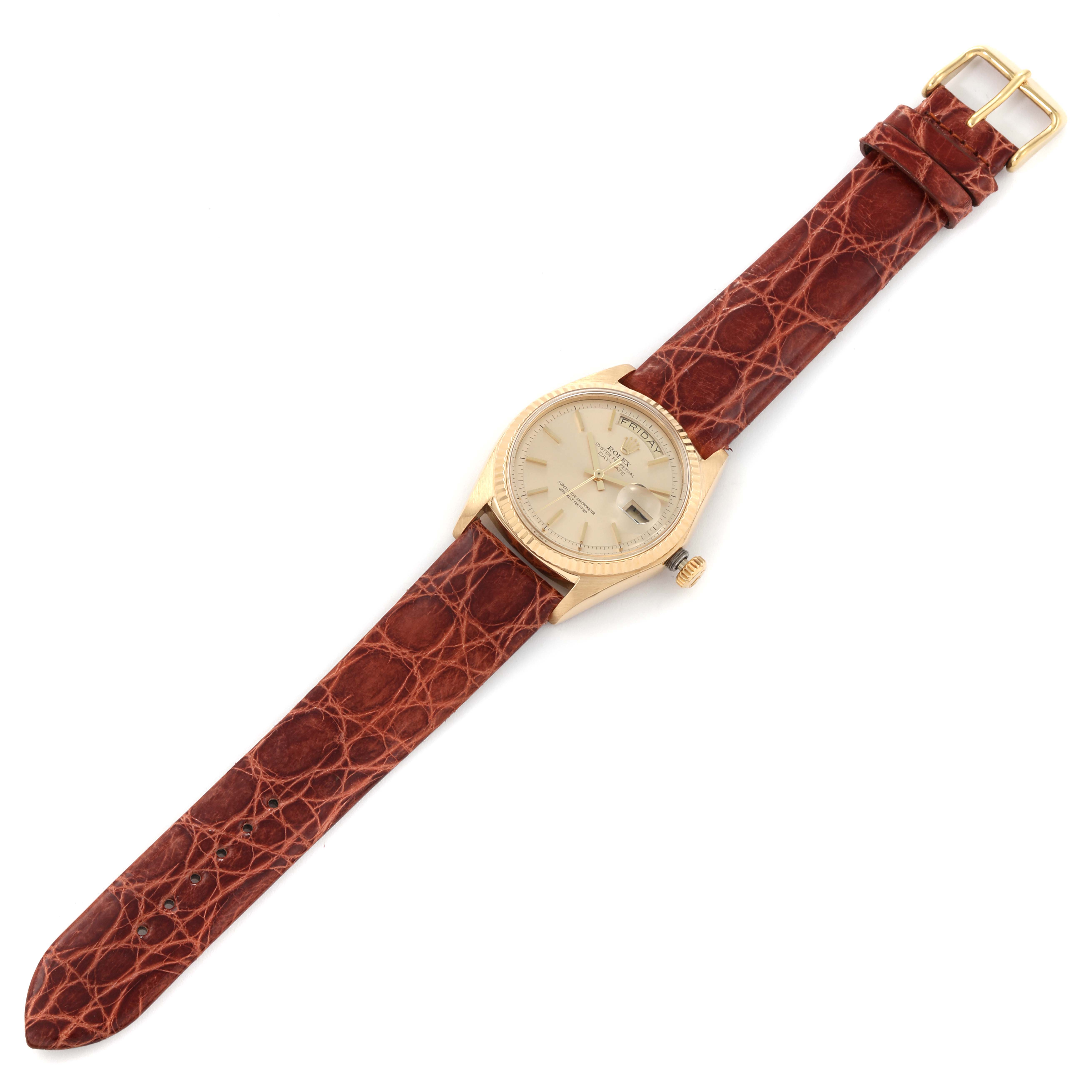 The image shows the Rolex President 1803 Men
s Yellow Gold Champagne Dial 1803 Men
s Yellow Gold Champagne Dial model watch from a top-down angle, highlighting the dial and brown leather strap.