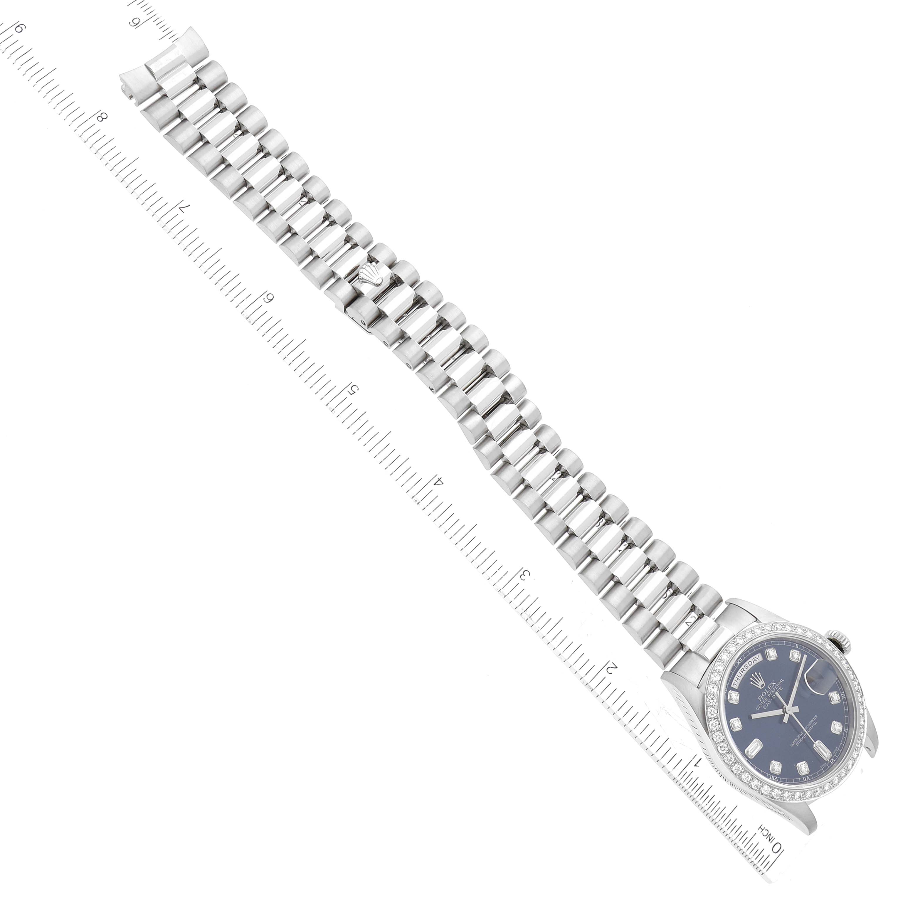 The image shows a top-down view of a Rolex President 18346 Men's Platinum Blue Dial 18346 Men's Platinum Blue Dial model watch with its band extended alongside a ruler.