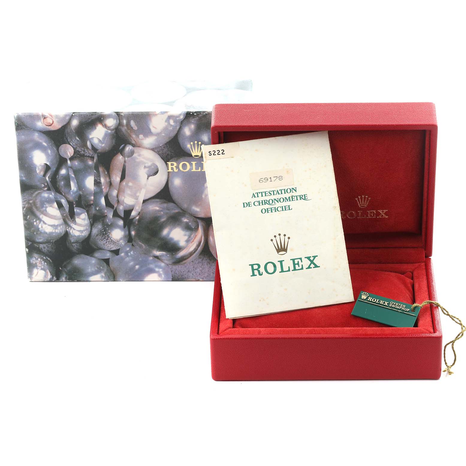The image shows Rolex packaging and papers for a President model, including a red box, certificate, and tag.