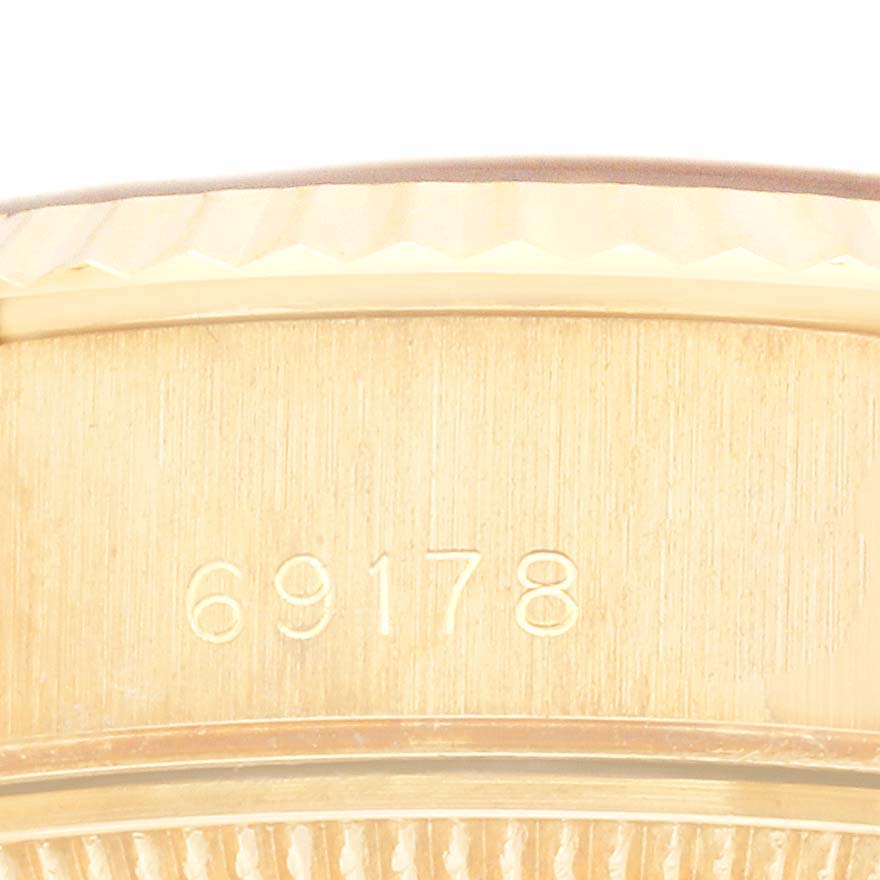 The image shows a close-up of the side of a Rolex President 69178 Women's Yellow Gold Black Dial 69178 Women's Yellow Gold Black Dial watch, focusing on the engraved model number 69178.