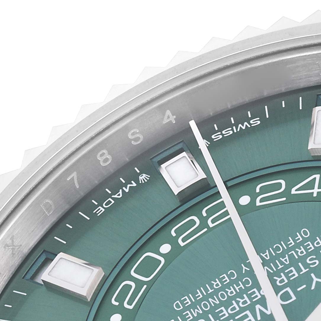 The image shows a close-up of the Rolex Sky-Dweller 336934 Men
s Steel and Gold (two tone) Green Dial 336934 Men
s Steel and Gold (two tone) Green Dial
s green dial, partial bezel, and indices, viewed from an oblique angle.