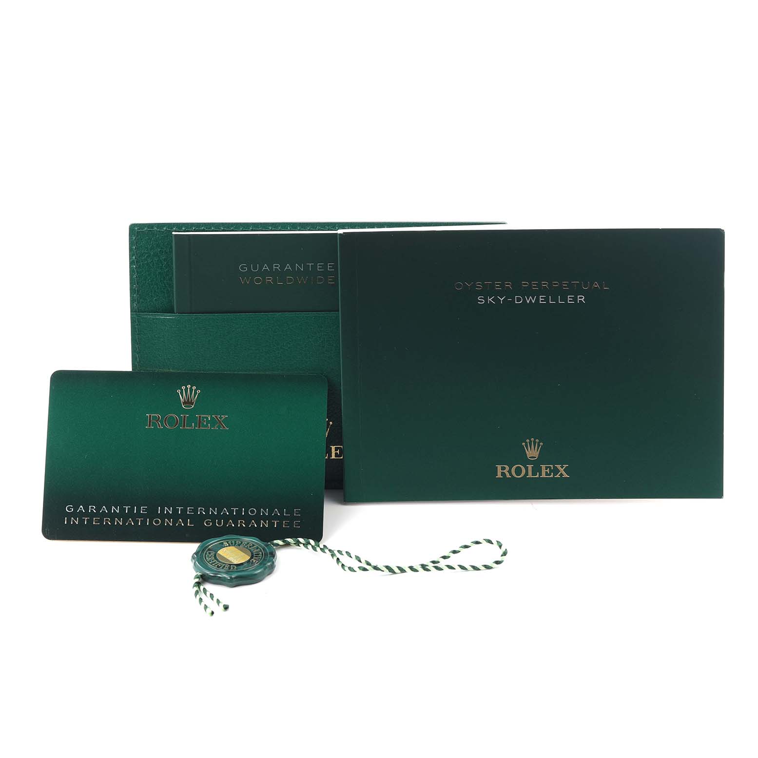 The image shows the packaging and accessories for a Rolex Sky-Dweller 336934 Men
s Stainless Steel Green Dial 336934 Men
s Stainless Steel Green Dial, including a guarantee card and booklet.