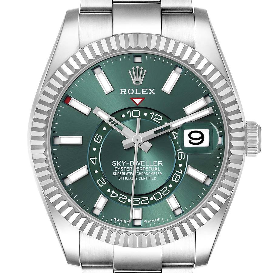 The Rolex Sky-Dweller is shown from the front, featuring a green dial, fluted bezel, and date display.