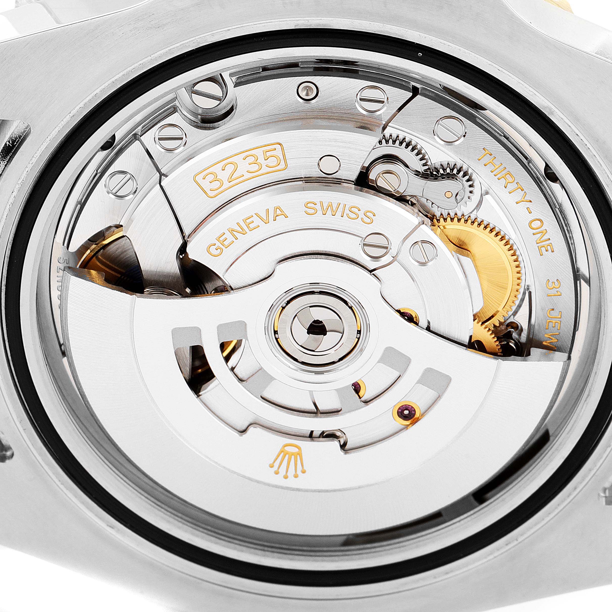 This image shows a close-up view of the movement mechanism in a Rolex Submariner 126613 Men
s Steel and Gold (two tone) Blue Dial 126613 Men
s Steel and Gold (two tone) Blue Dial watch, including gears, rotors, and inscriptions.