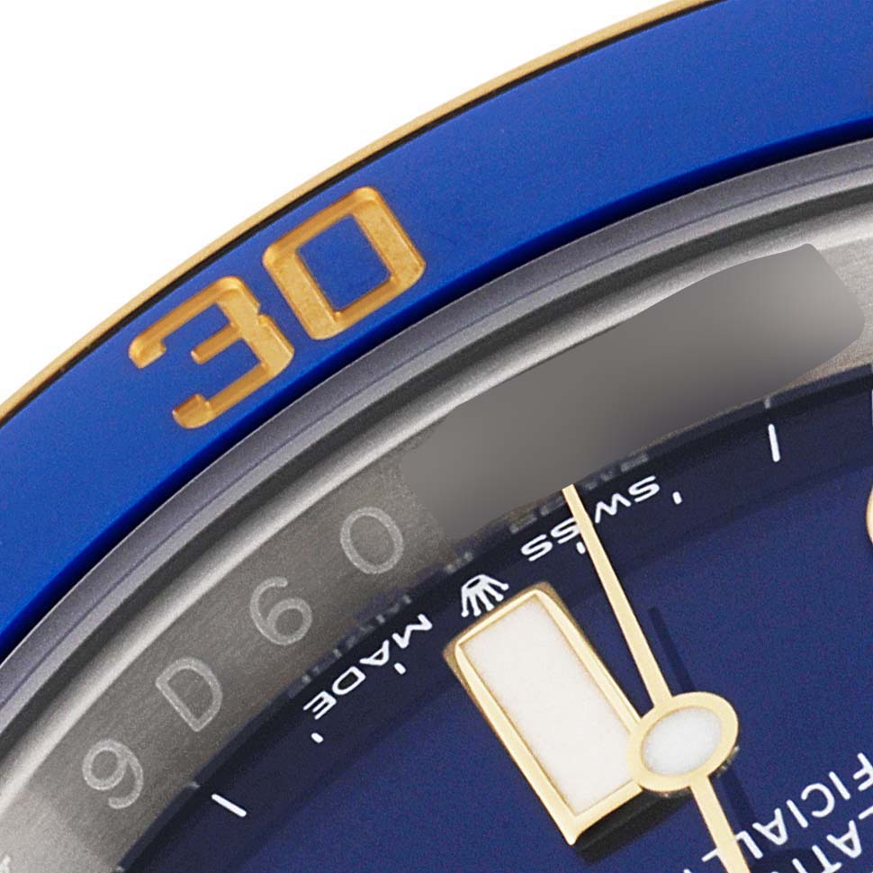 This image shows a close-up of the bezel and dial of a Rolex Submariner 126613 Men
s Steel and Gold (two tone) Blue Dial 126613 Men
s Steel and Gold (two tone) Blue Dial watch, focusing on the "30" minute mark and part of the hour hand.