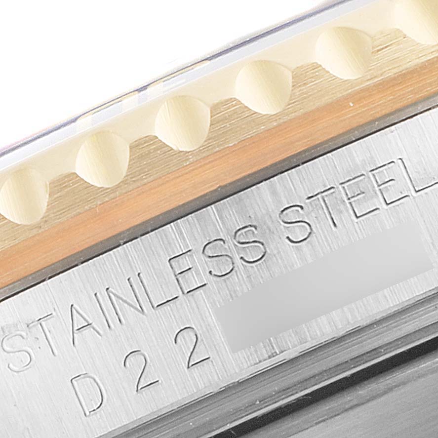 This image shows a close-up angle of the bezel and the engraved stainless steel case back of a Rolex Submariner 16613 Men's Steel and Gold (two tone) Blue Dial 16613 Men's Steel and Gold (two tone) Blue Dial watch.