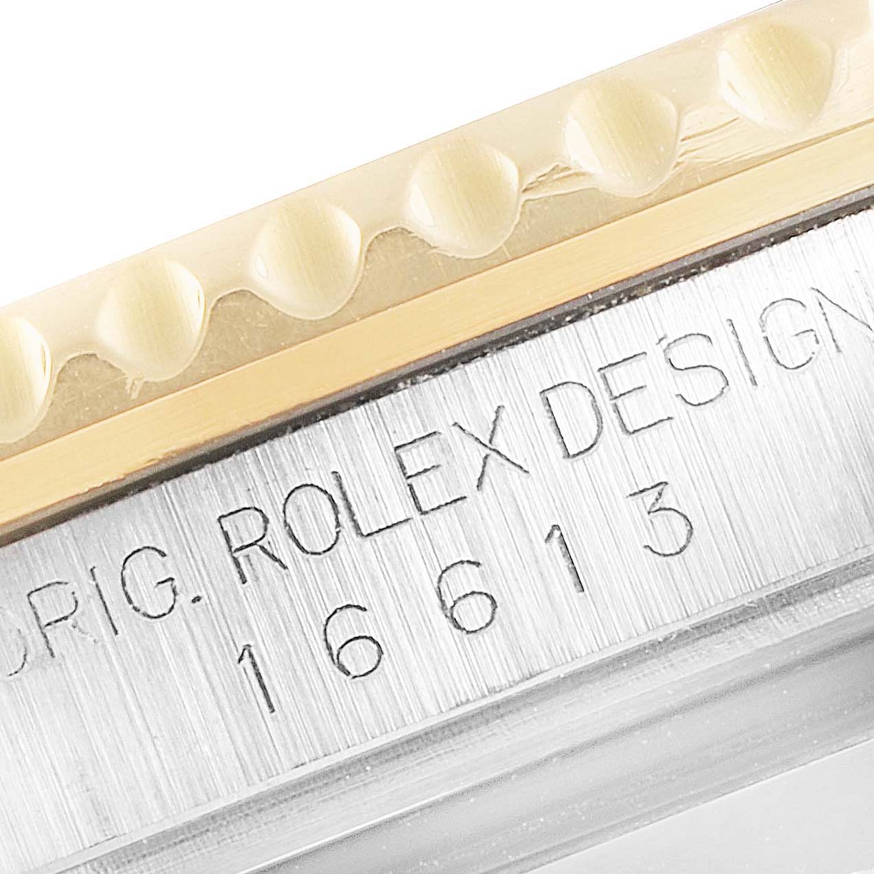 This image shows a close-up of the bezel and engraved model number on a Rolex Submariner 16613 Men's Steel and Gold (two tone) Blue Dial 16613 Men's Steel and Gold (two tone) Blue Dial watch.