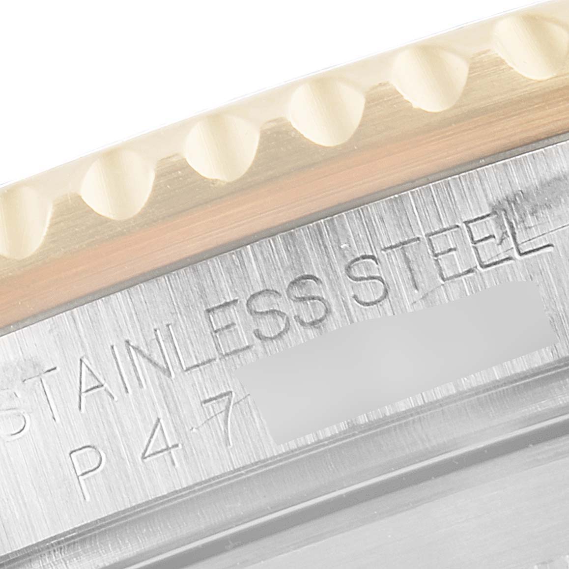 This image shows a close-up of the engraved side of the bezel and stainless steel case of a Rolex Submariner 16613 Men's Steel and Gold (two tone) Blue Dial 16613 Men's Steel and Gold (two tone) Blue Dial.