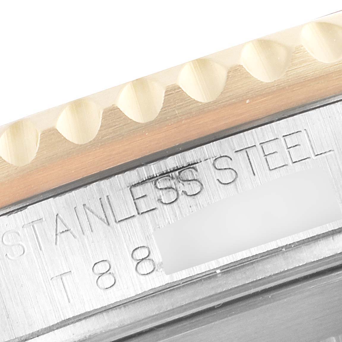 A close-up of the bezel and engraved stainless steel text on a Rolex Submariner 16613 Men's Steel and Gold (two tone) Grey Dial 16613 Men's Steel and Gold (two tone) Grey Dial watch.