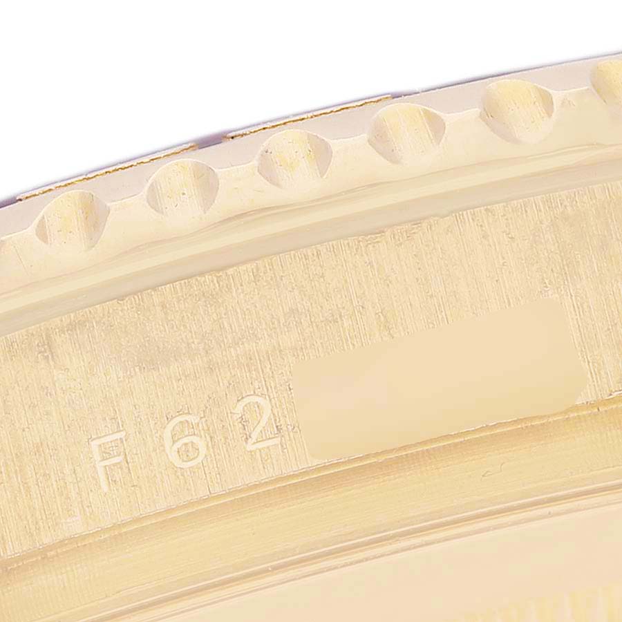 This image shows a close-up of the bezel and part of the engraving on a Rolex Yacht-Master 16628 Men's Yellow Gold White Dial 16628 Men's Yellow Gold White Dial watch.
