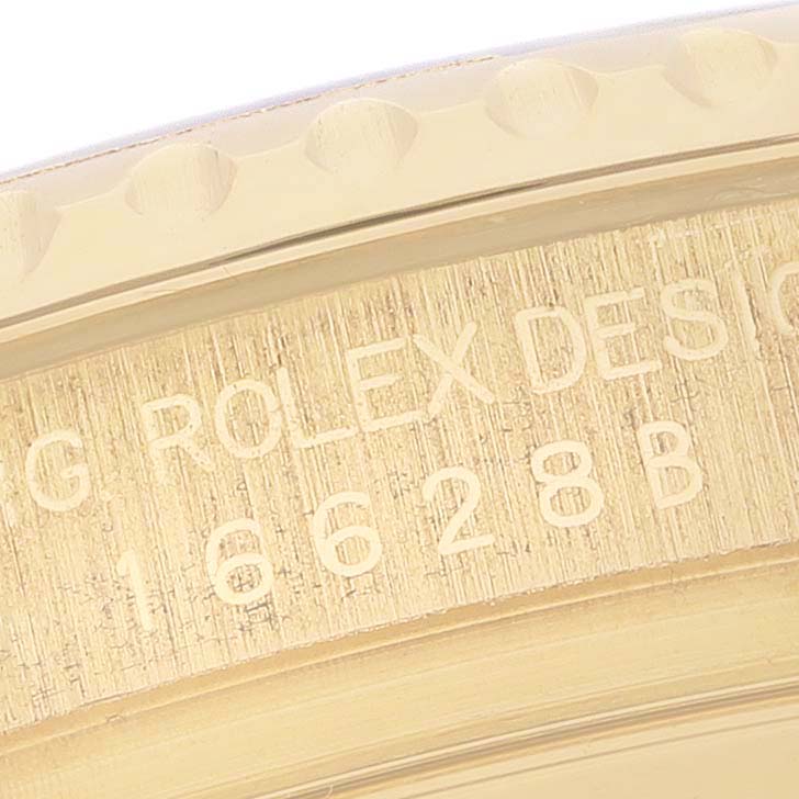 This close-up image shows the engraved details on the bezel and case of the Rolex Yacht-Master 16628 Men's Yellow Gold White Dial 16628 Men's Yellow Gold White Dial watch.
