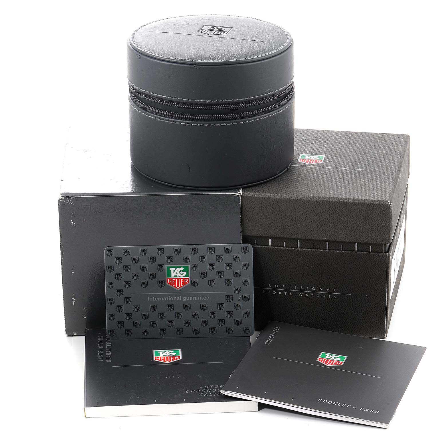 The image shows the box, warranty card, booklet, and case for a Tag Heuer Carrera CV2010 Men
s Stainless Steel Black Dial CV2010 Men
s Stainless Steel Black Dial watch, viewed from a slightly elevated angle.