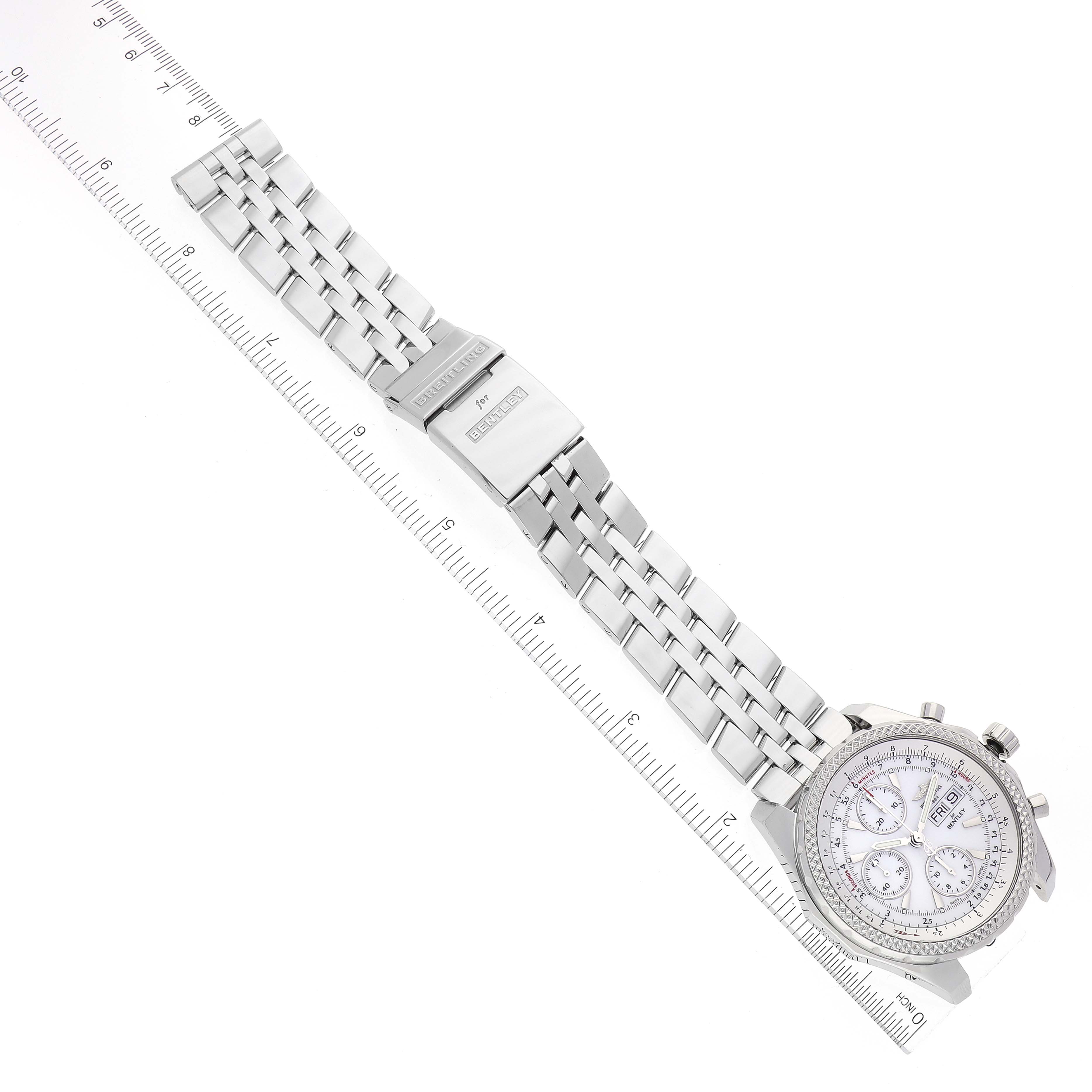This image shows a top-down view of a Breitling Bentley A13362 Men's Stainless Steel White Dial A13362 Men's Stainless Steel White Dial watch, including the face, bezel, and entire metal bracelet next to a ruler.