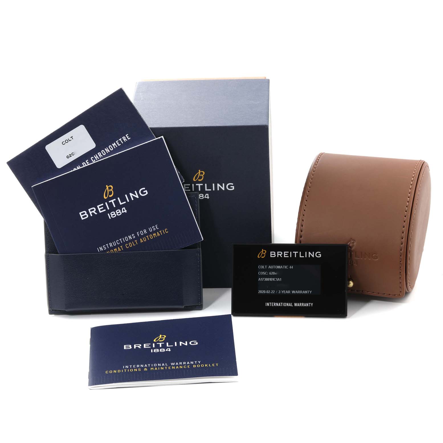 The image shows accessories for the Breitling Colt A17388 Men's Stainless Steel Blue Dial A17388 Men's Stainless Steel Blue Dial watch, including manuals, warranty cards, and a watch case.
