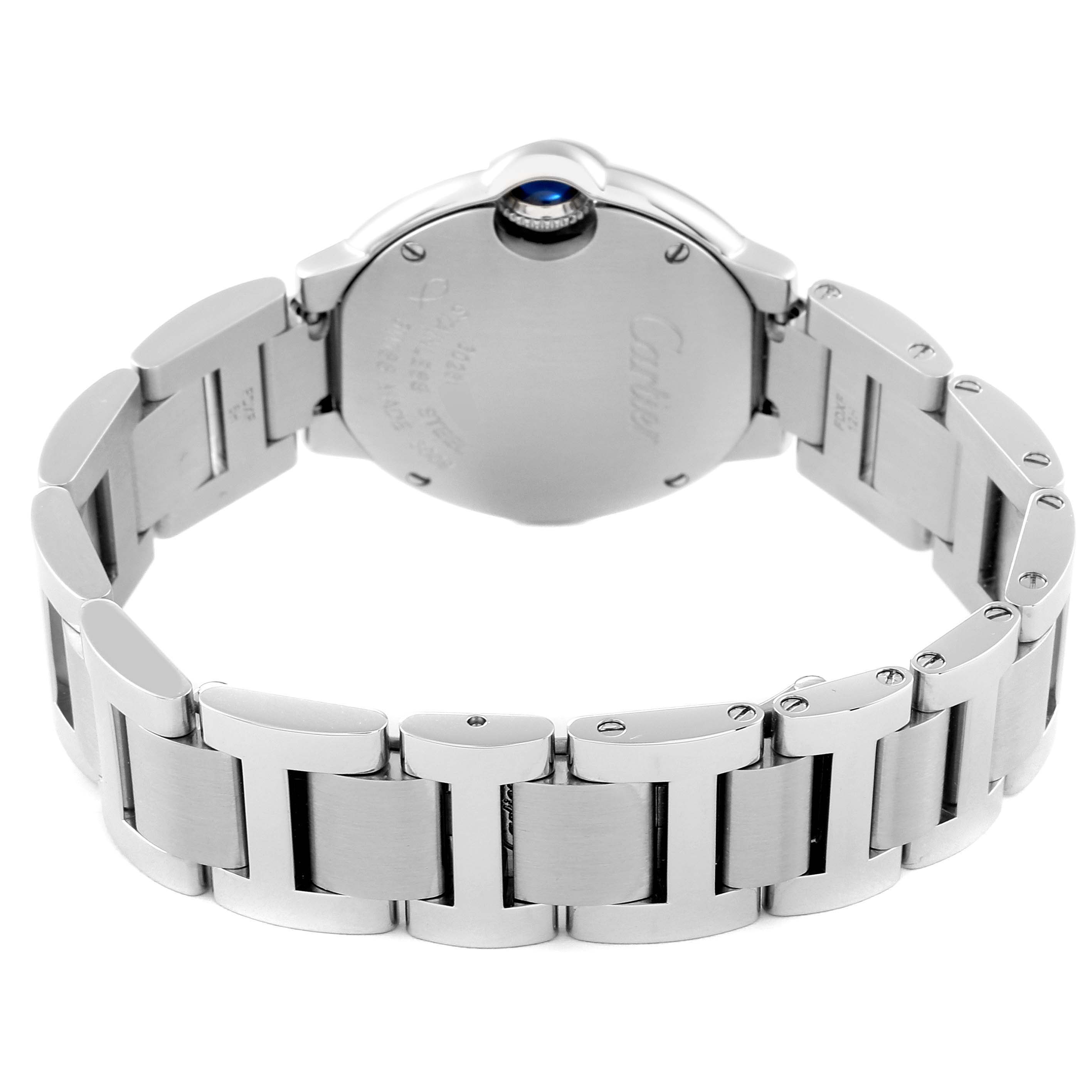 The image shows the back view of a Ballon Bleu watch by Cartier, highlighting the watch case, bracelet, and blue cabochon crown.