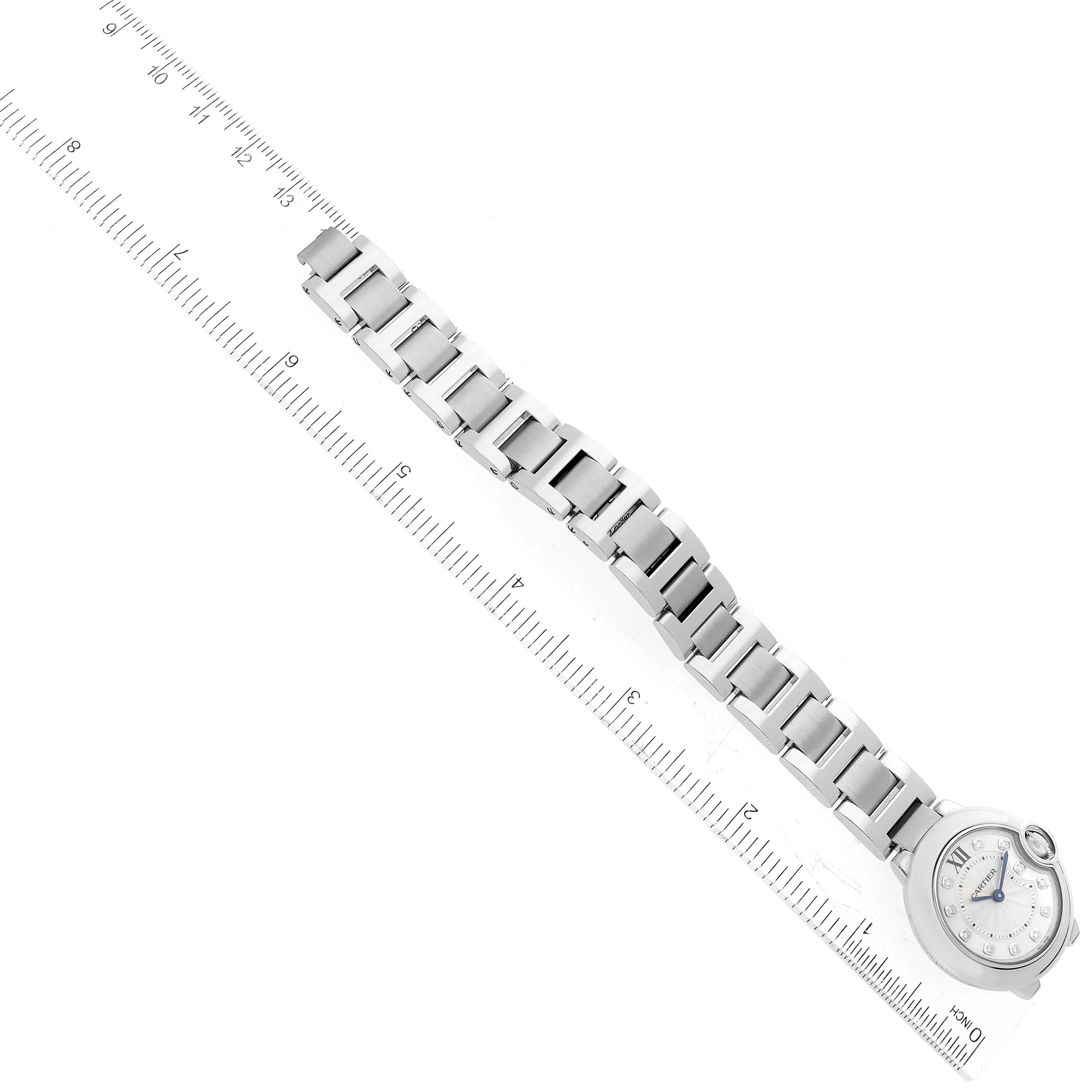 The image shows the face and entire band of a Cartier Ballon Bleu WE902073 Women's Stainless Steel Silver Dial WE902073 Women's Stainless Steel Silver Dial watch placed next to a ruler for measurement.