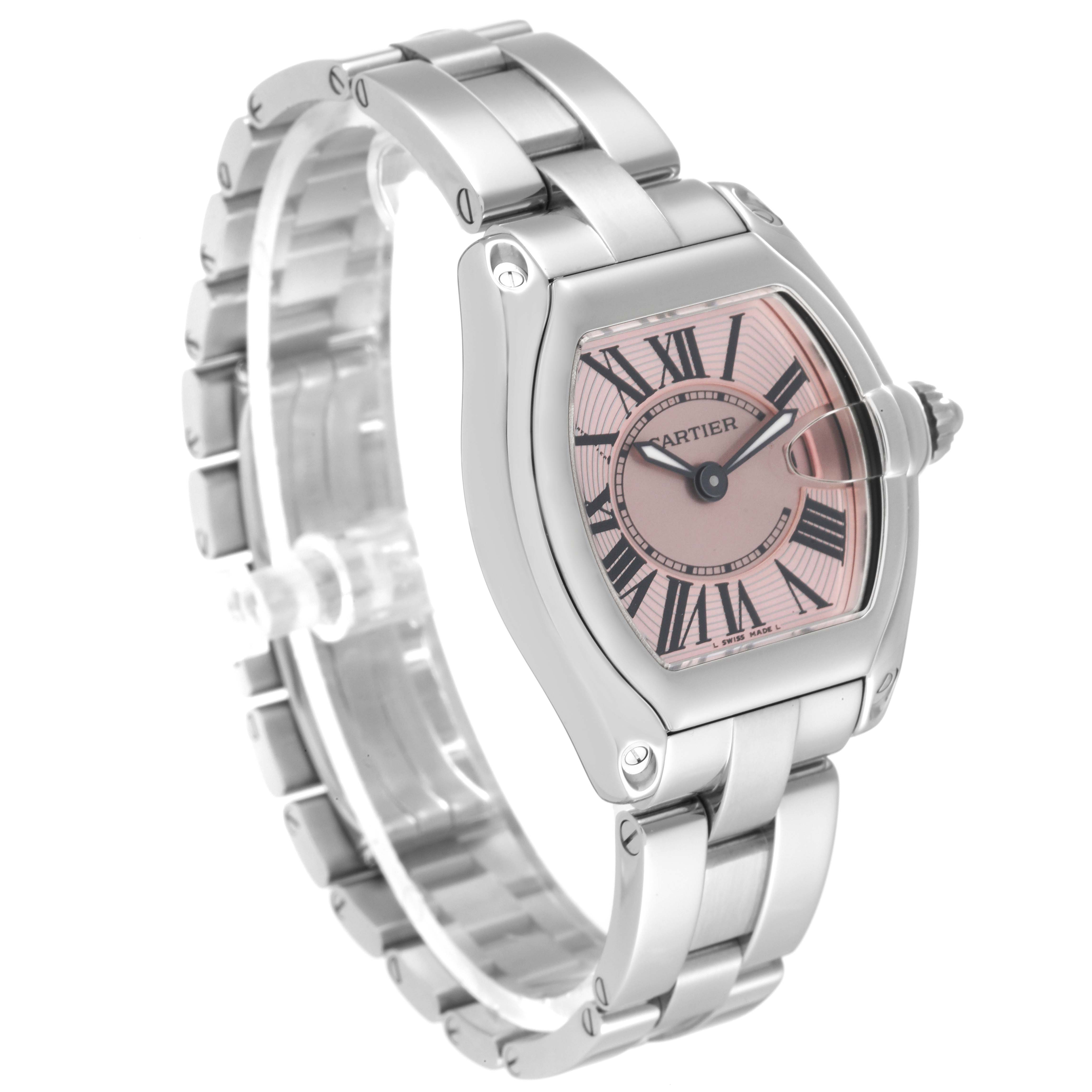 The Cartier Roadster W62017V3 Women's Stainless Steel Pink Dial W62017V3 Women's Stainless Steel Pink Dial watch is shown at a three-quarter angle, featuring a pink dial, Roman numerals, and a metal bracelet.