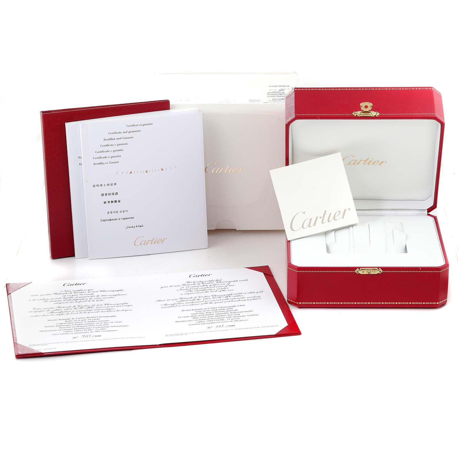 The image shows the packaging, instruction manuals, and warranty documents of the Rotonde model by Cartier from a front angle.