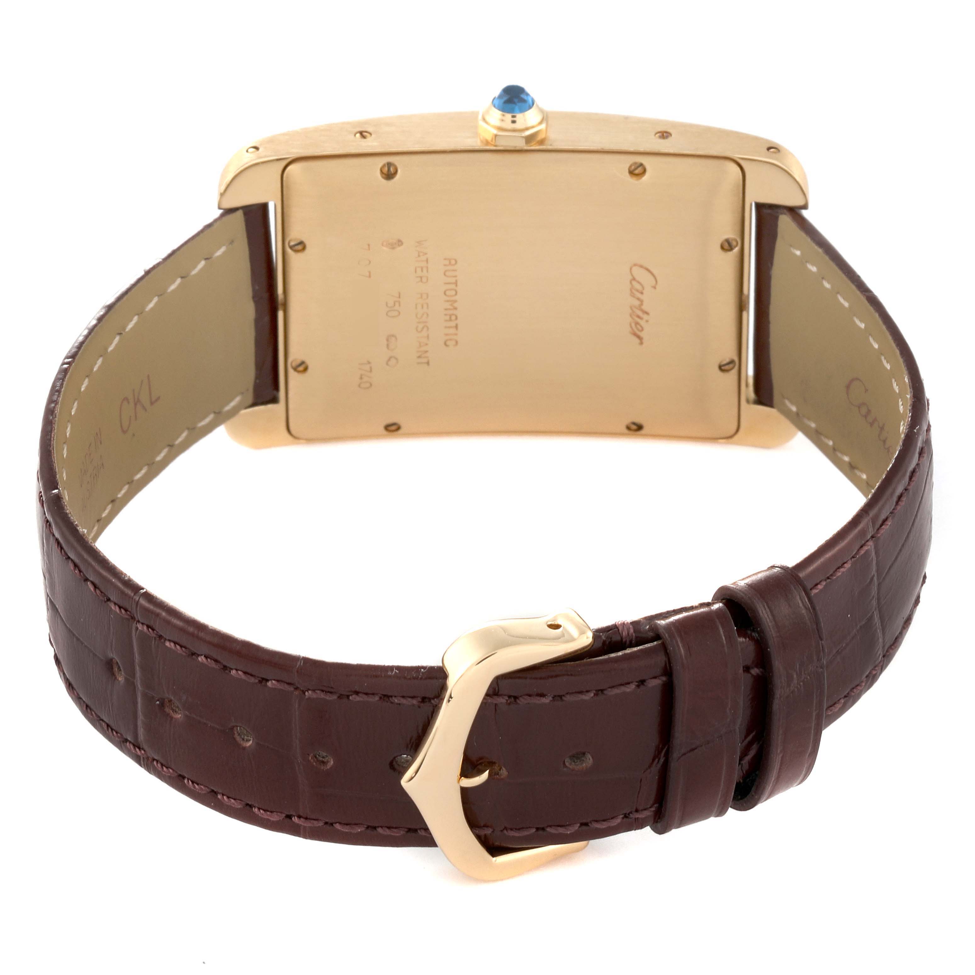 The image shows the back case and strap of the Cartier Tank Américaine watch, highlighting the buckle and case back details.