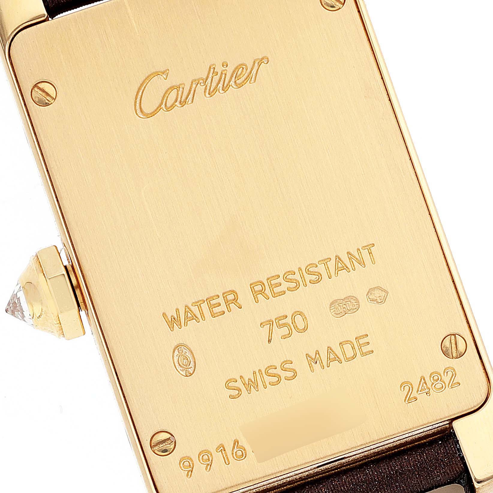 This image shows the case back and crown of a Cartier Tank Americaine 2482 Women's Yellow Gold Brown Dial 2482 Women's Yellow Gold Brown Dial watch.