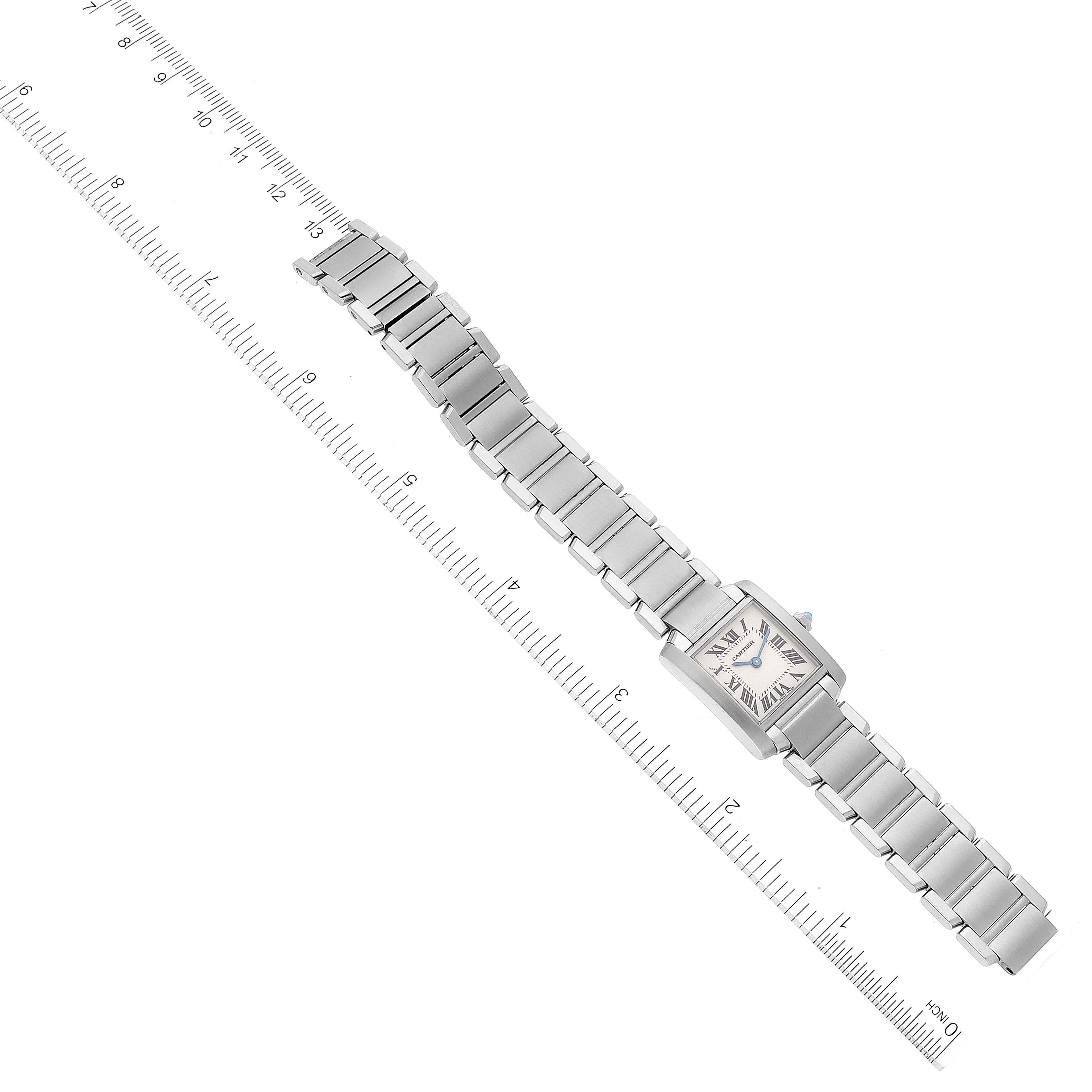 The image shows a top view of a Cartier Tank Francaise W51008Q3 Women's Stainless Steel Silver Dial W51008Q3 Women's Stainless Steel Silver Dial model watch, laid alongside a ruler for size reference.