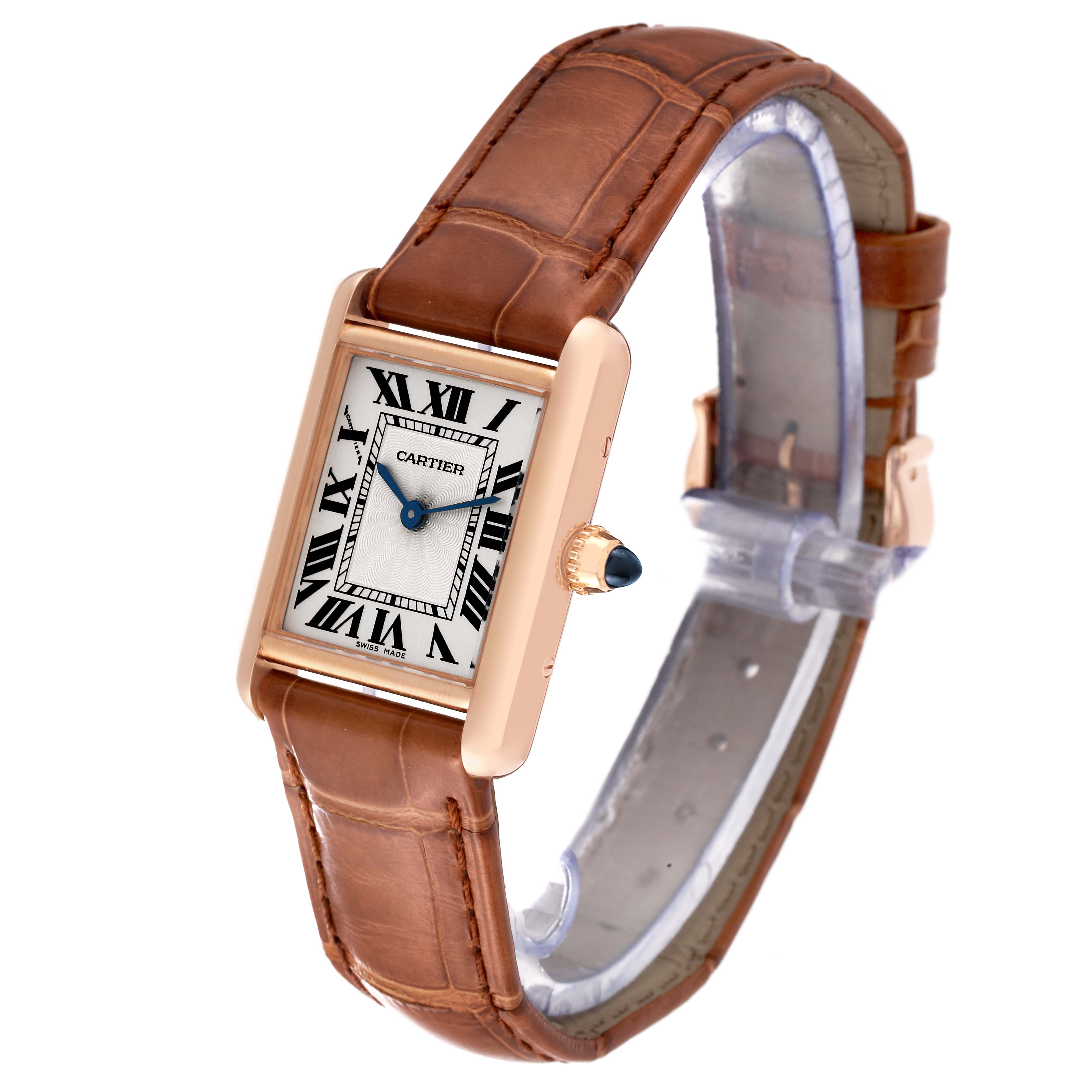 This image shows a Cartier Tank Louis WGTA0010 Women's Rose Gold Silver Dial WGTA0010 Women's Rose Gold Silver Dial watch at an angle, highlighting its rectangular dial, leather strap, and distinctive crown.