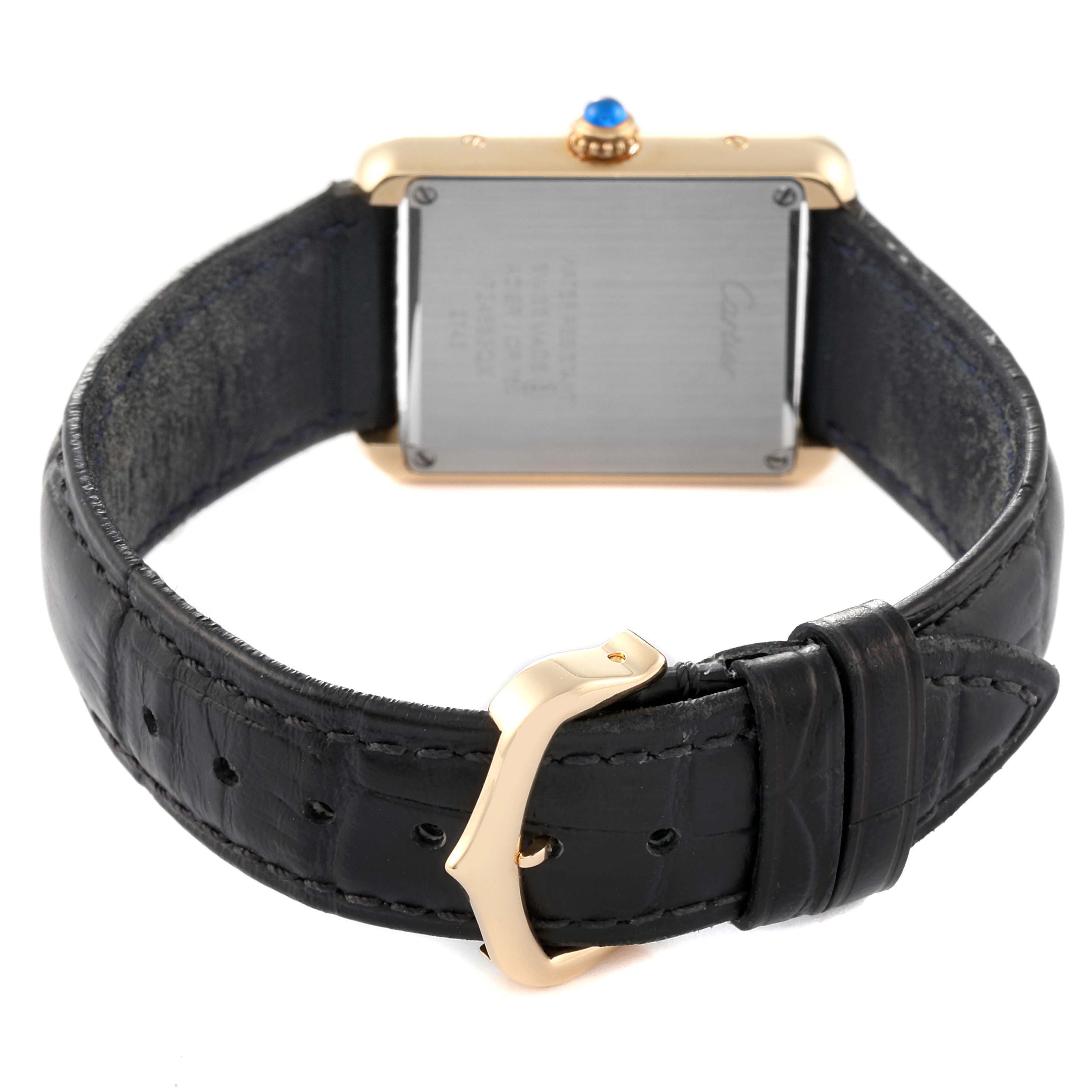 The image shows the back of the Cartier Tank Solo W1018755 Women
s Steel and Gold (two tone) Silver Dial W1018755 Women
s Steel and Gold (two tone) Silver Dial watch and its leather strap, highlighting the buckle and case back details.