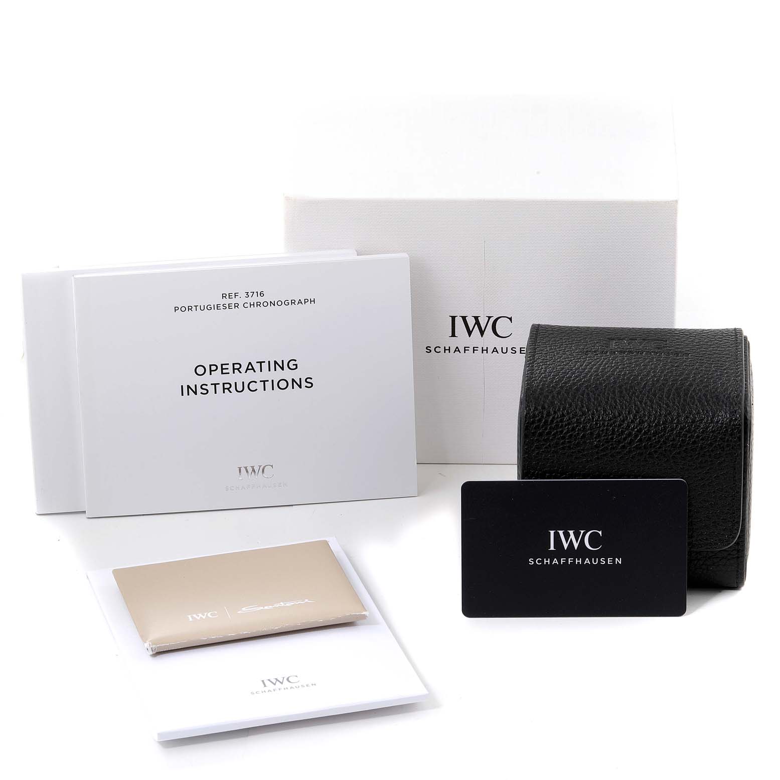 The image shows accessories for the IWC Portuguese IW371615 Men's Stainless Steel Green Dial IW371615 Men's Stainless Steel Green Dial model, including operating instructions, a box, a booklet, and a travel case.