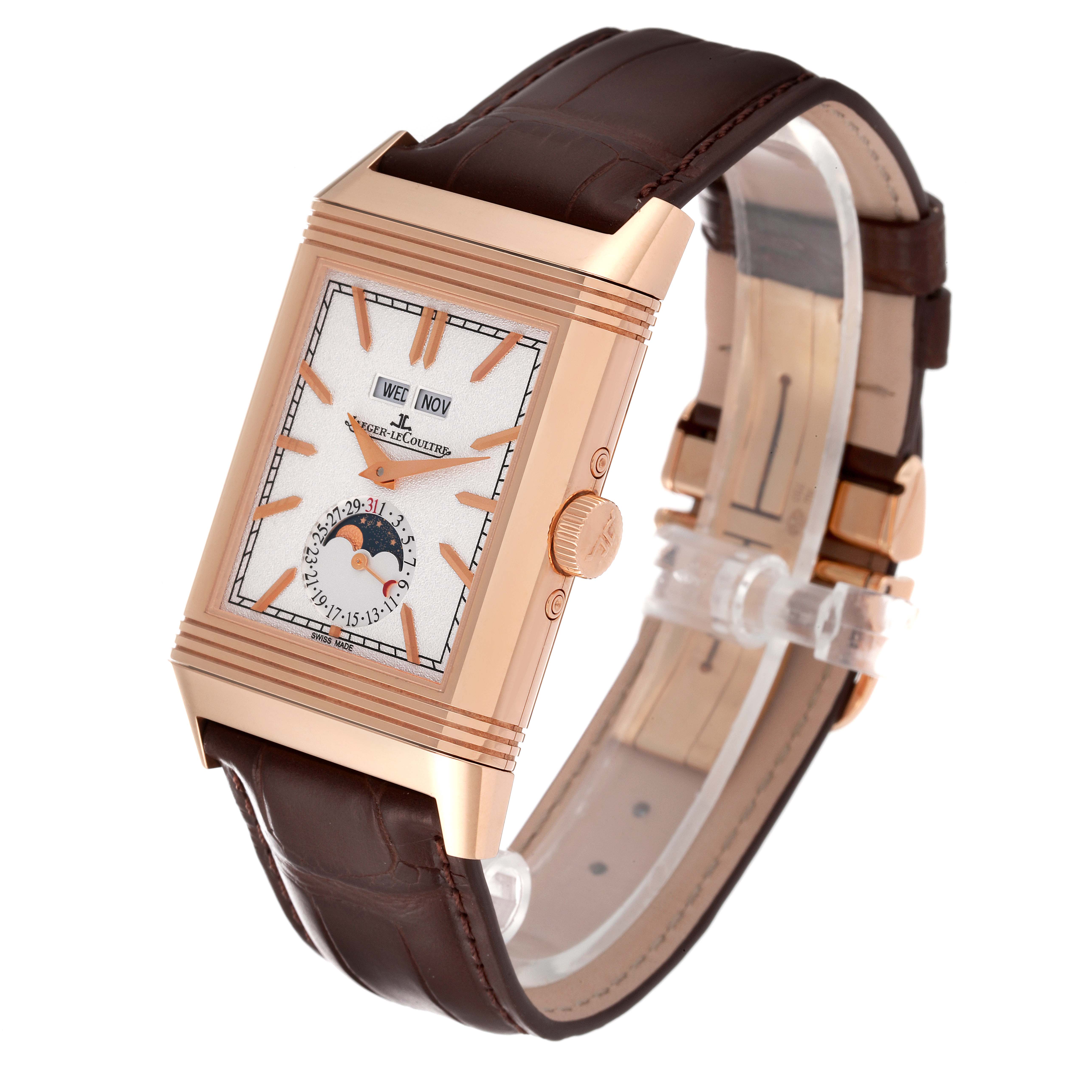 The image shows a Jaeger-LeCoultre Reverso watch at a 3/4 angle, highlighting its rose gold case, rectangular dial, and brown leather strap.
