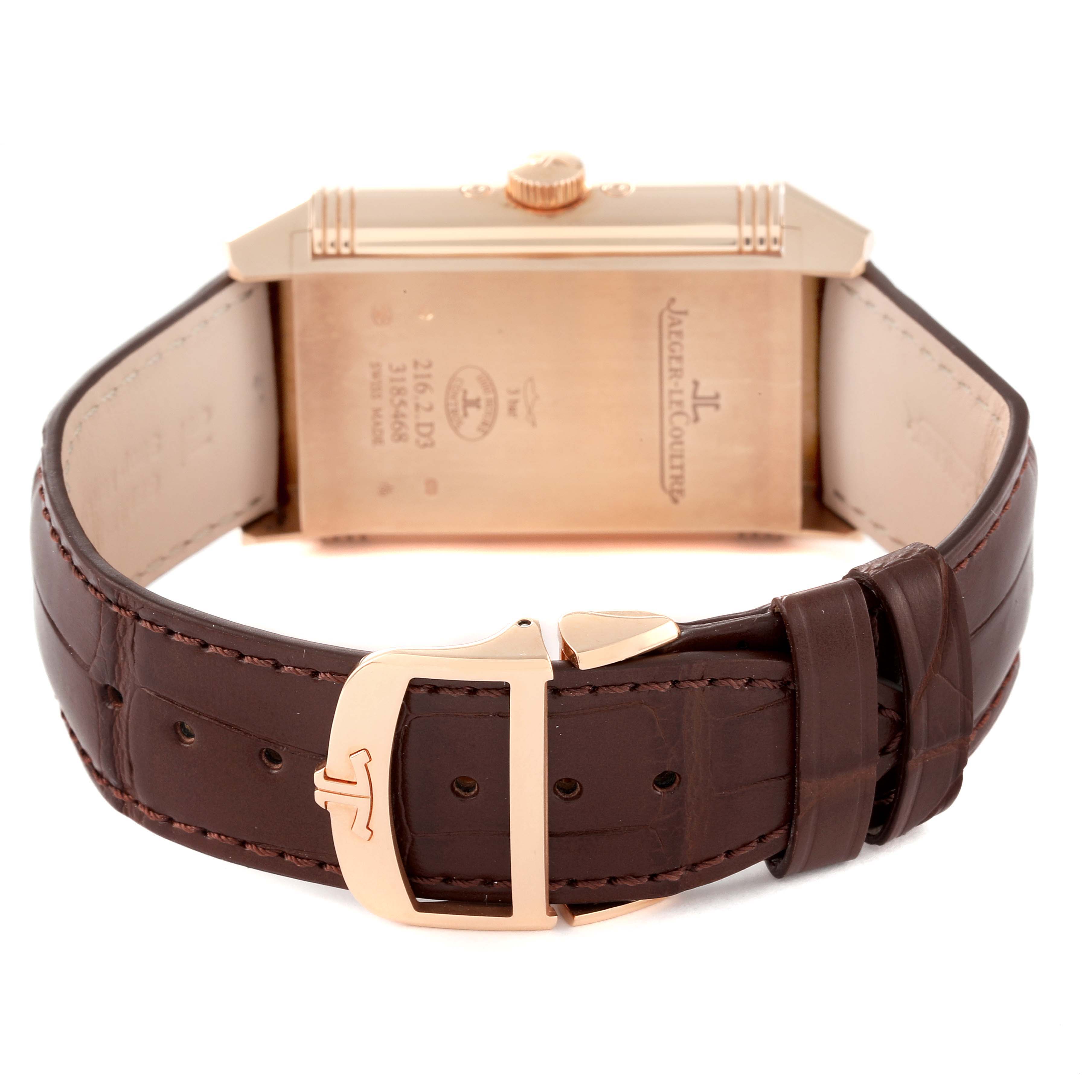 The image shows the back view of a Jaeger-LeCoultre Reverso watch, featuring its strap, buckle, and case back details.