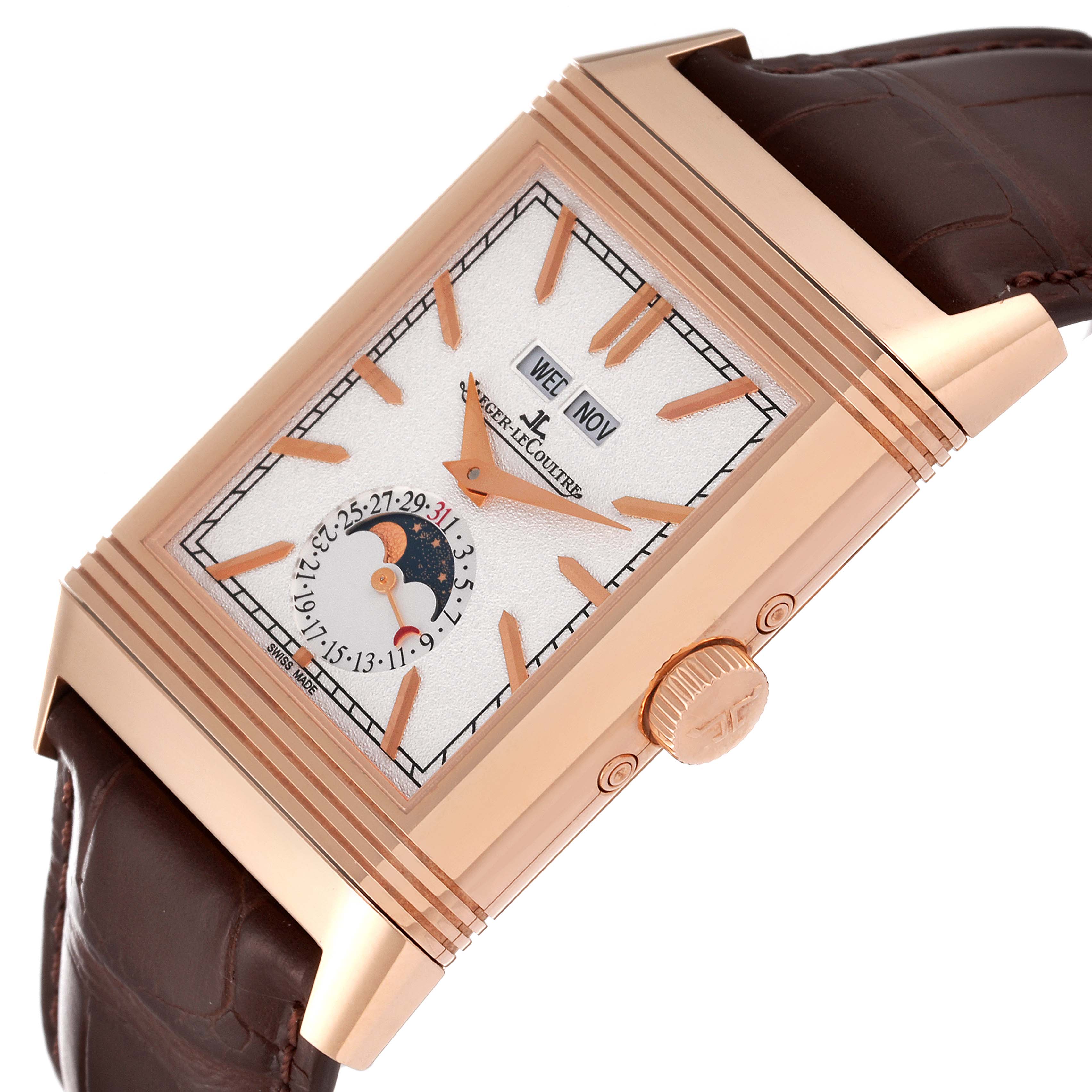 The Jaeger-LeCoultre Reverso watch is shown at an angle, highlighting the crown, case, dial, leather strap, and day-date sub-dials.
