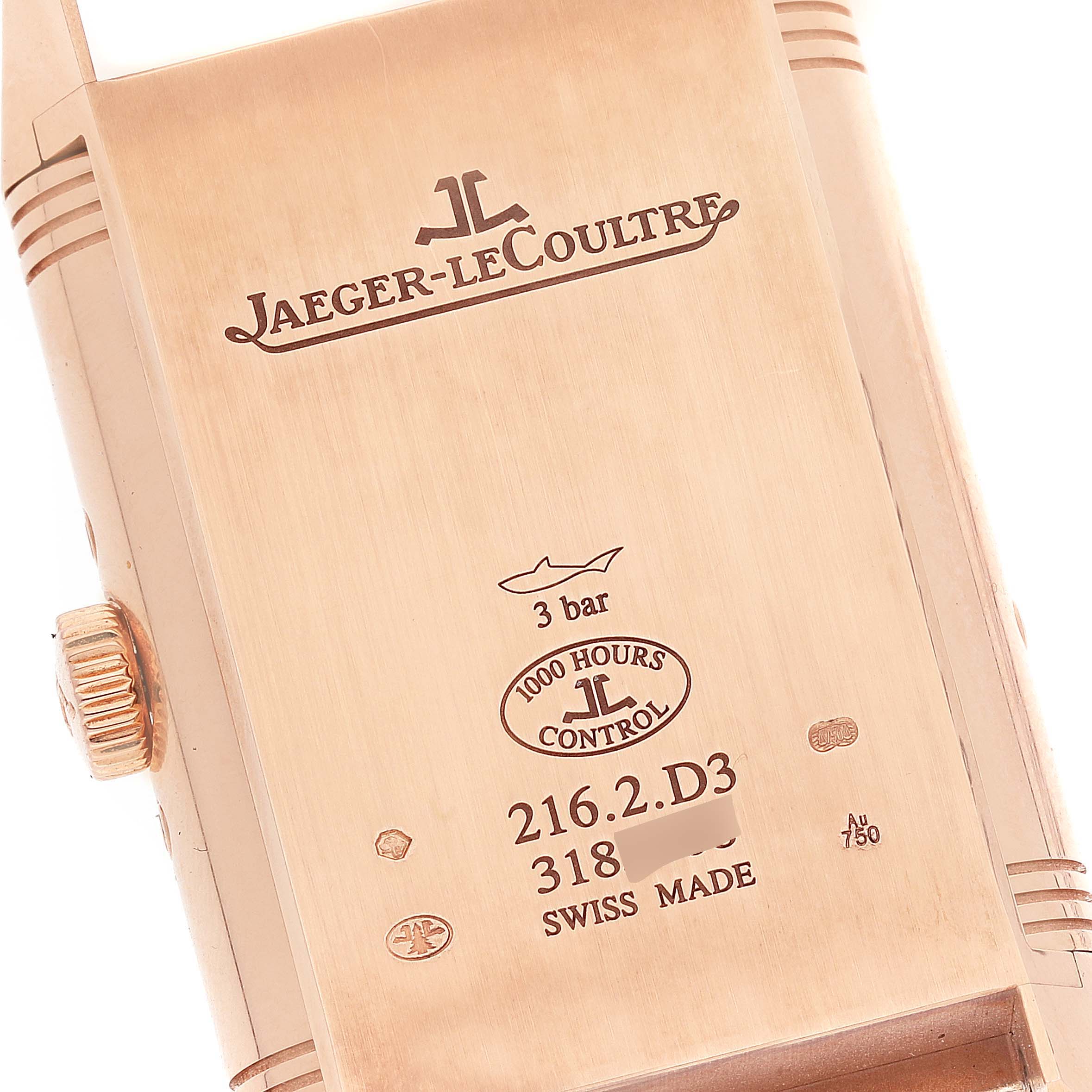 The image shows the back of the Jaeger-LeCoultre Reverso watch in a close-up angle, revealing engravings and the crown.