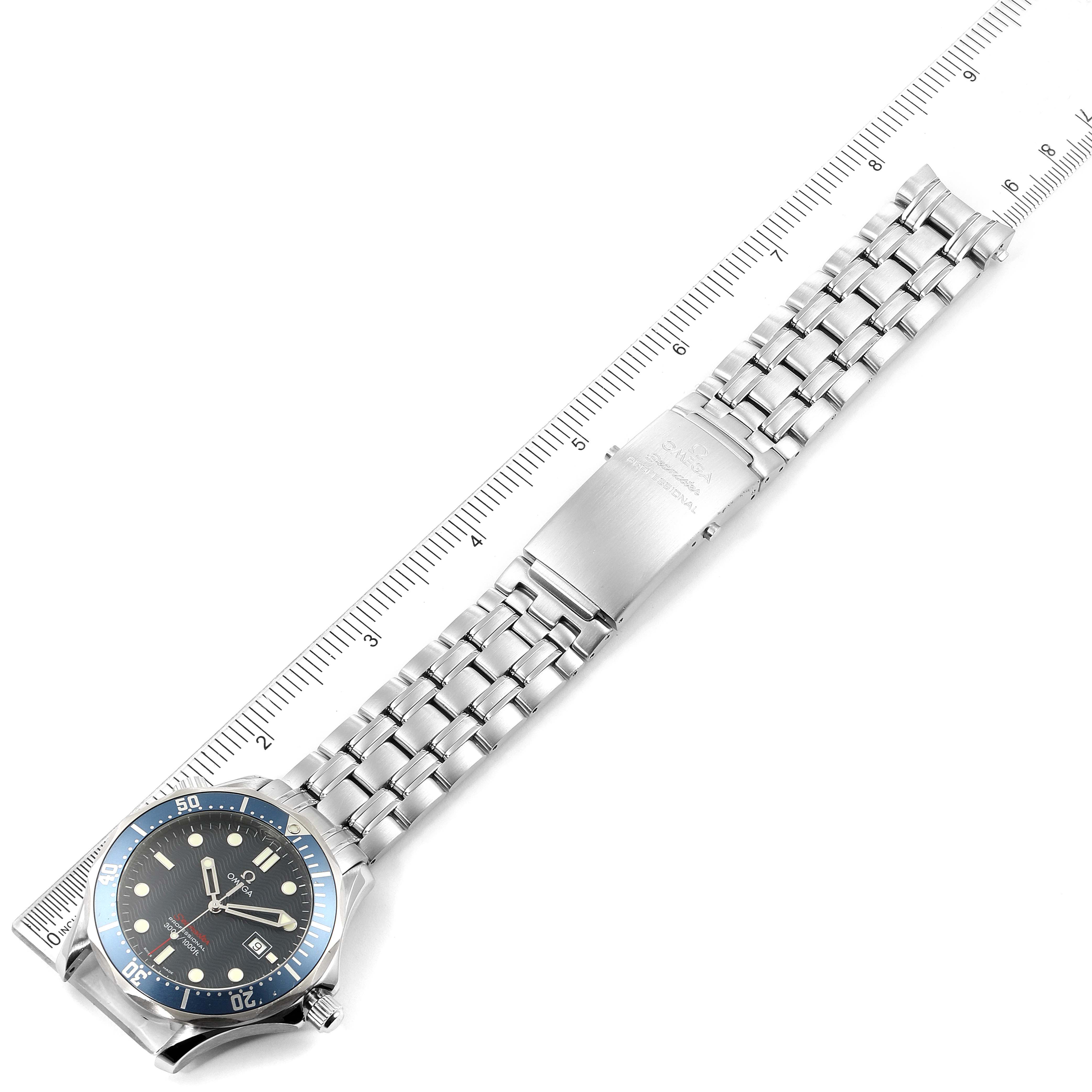The image shows an Omega Seamaster 2221.80.00 Men
s Stainless Steel Blue Dial 2221.80.00 Men
s Stainless Steel Blue Dial watch laid flat with a ruler for scale, displaying the dial, bezel, bracelet, and clasp.