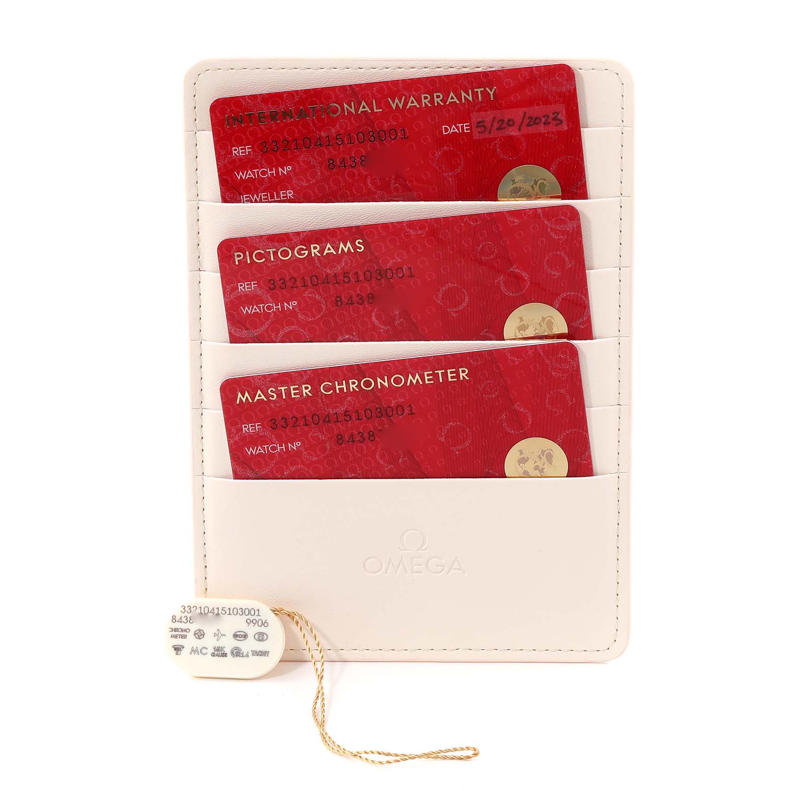 This is an angled view of the Omega Speedmaster 332.10.41.51.03.001 Men's Stainless Steel Blue Dial 332.10.41.51.03.001 Men's Stainless Steel Blue Dial's documentation, showing warranty cards and a tag.