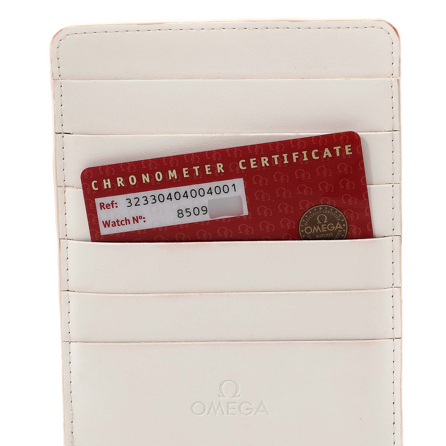 The image shows the chronometer certificate card for the Omega Speedmaster 323.30.40.40.04.001 Men's Stainless Steel White Dial 323.30.40.40.04.001 Men's Stainless Steel White Dial watch, partially inserted in a white leather cardholder.