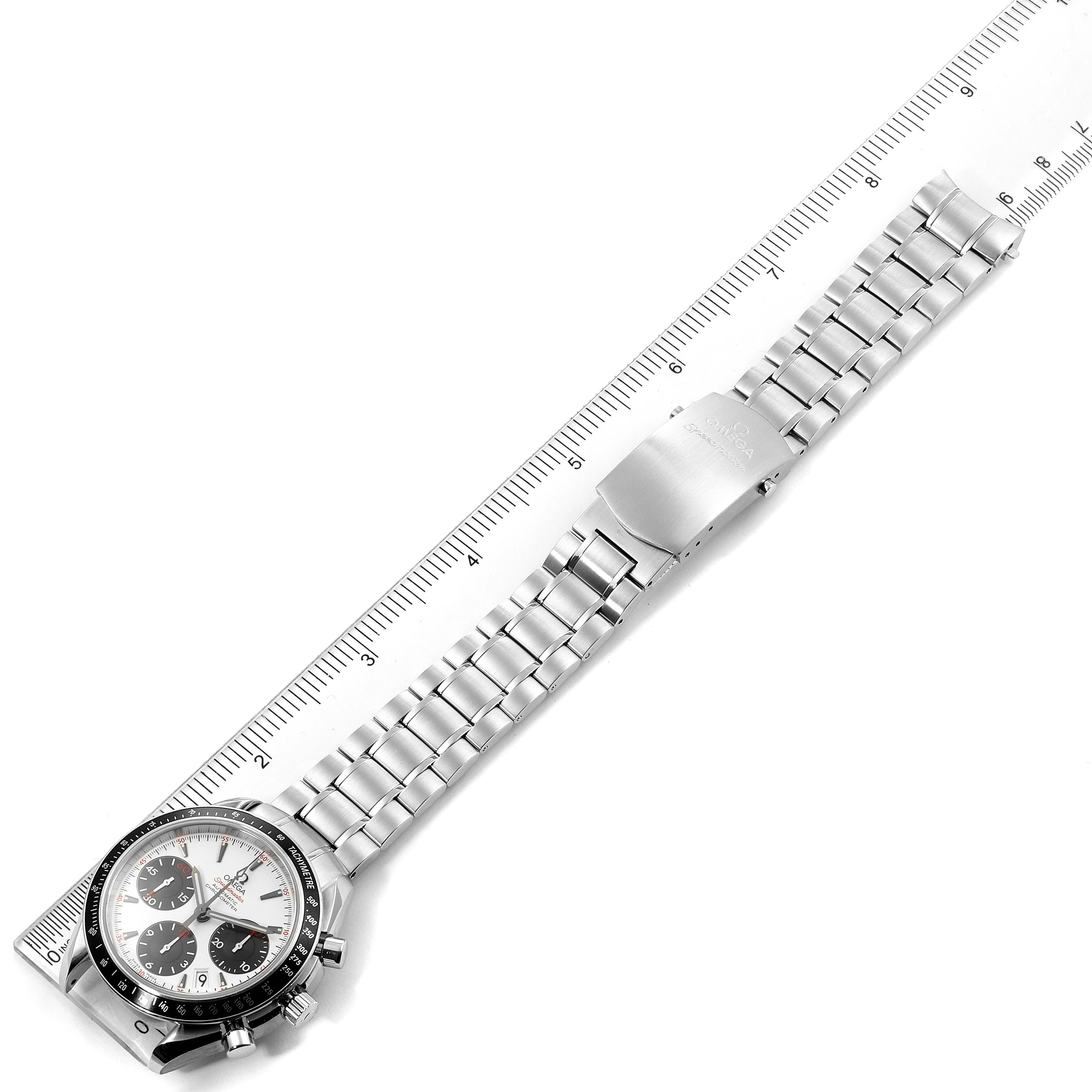 The image shows an Omega Speedmaster 323.30.40.40.04.001 Men's Stainless Steel White Dial 323.30.40.40.04.001 Men's Stainless Steel White Dial watch laid flat with its face and metallic bracelet visible alongside a ruler.