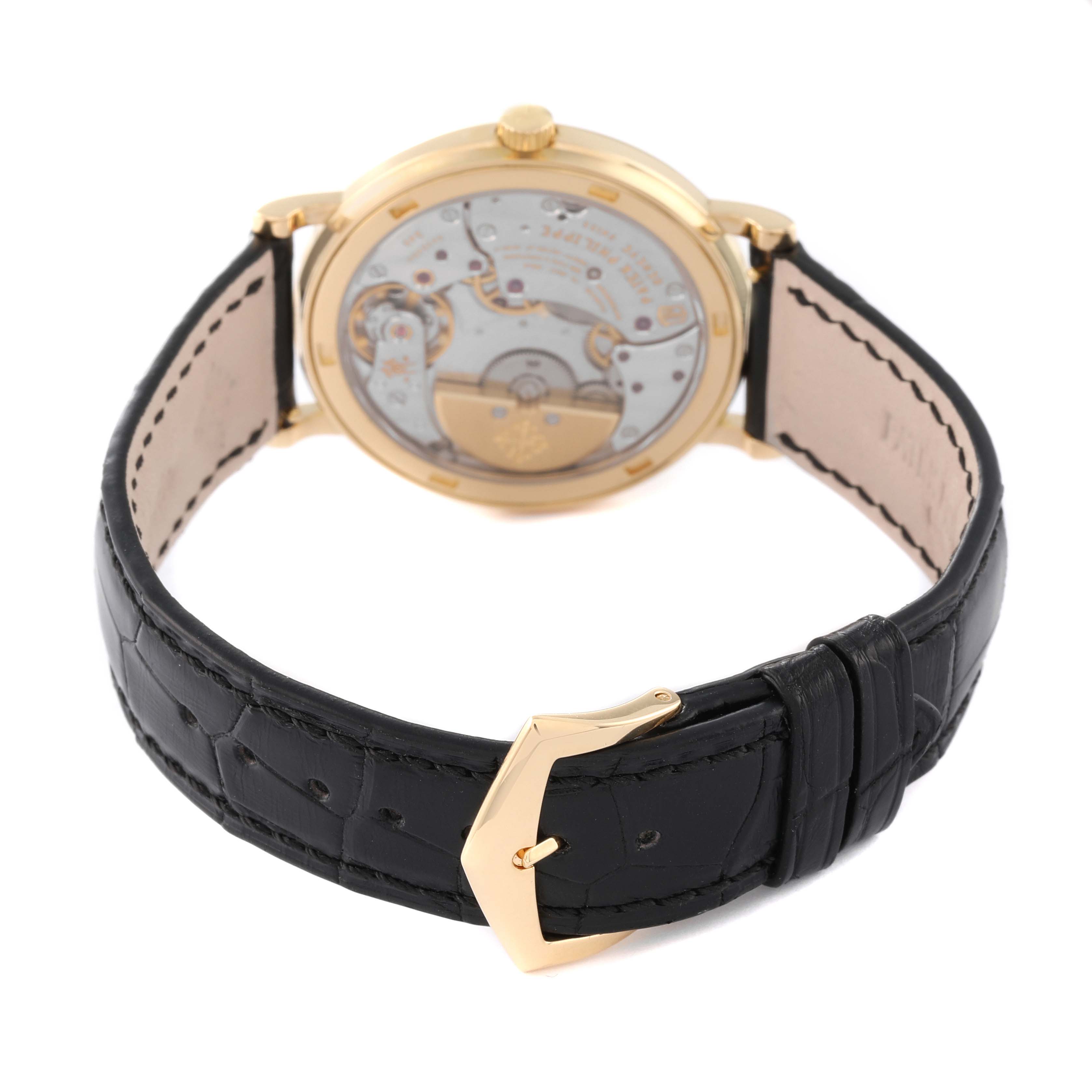 The image shows the back view of a Patek Philippe Calatrava 5120J Men's Yellow Gold White Dial 5120J Men's Yellow Gold White Dial watch, highlighting its leather strap and display case back.