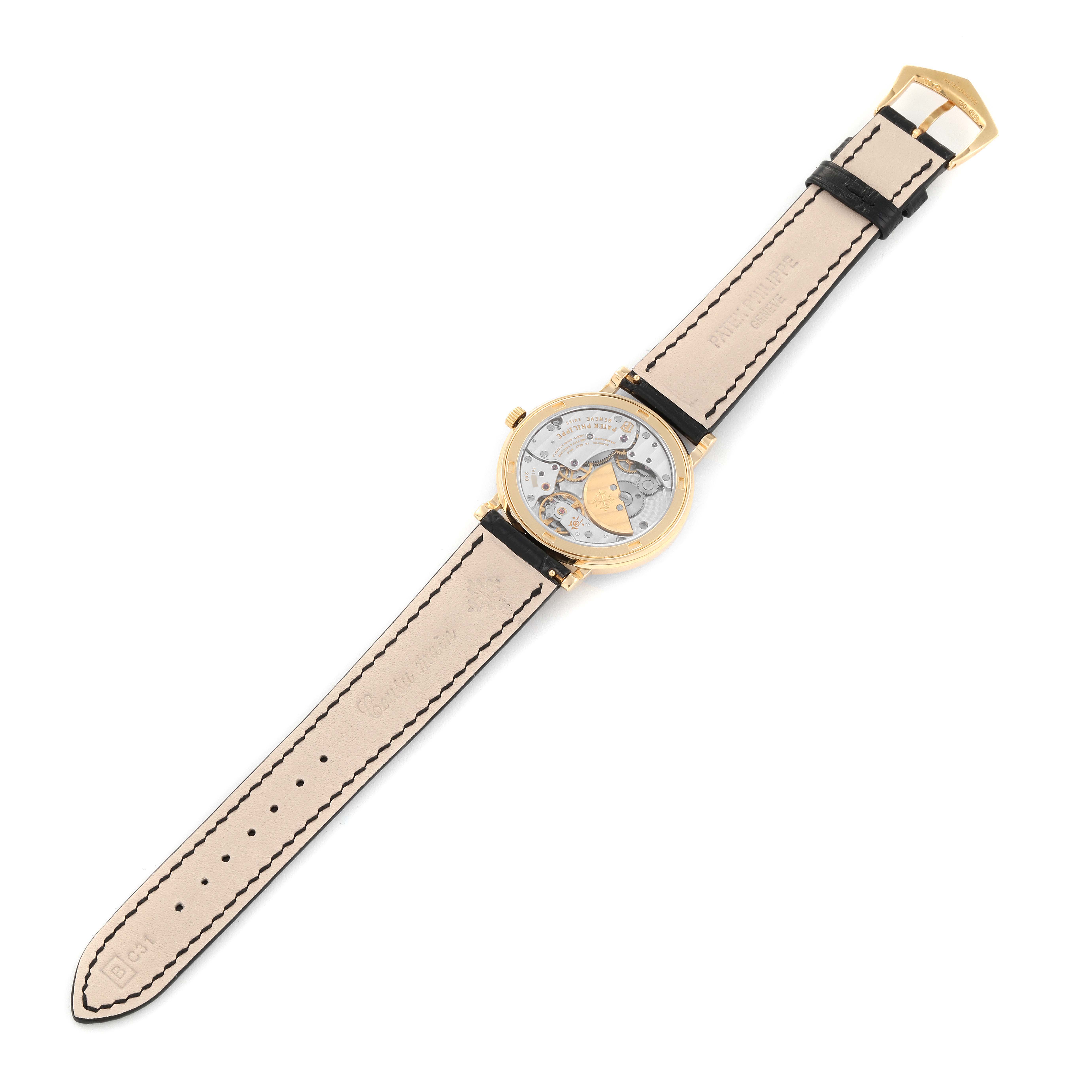 The image shows the back of the Patek Philippe Calatrava 5120J Men's Yellow Gold White Dial 5120J Men's Yellow Gold White Dial watch, displaying the movement and the entire leather strap.