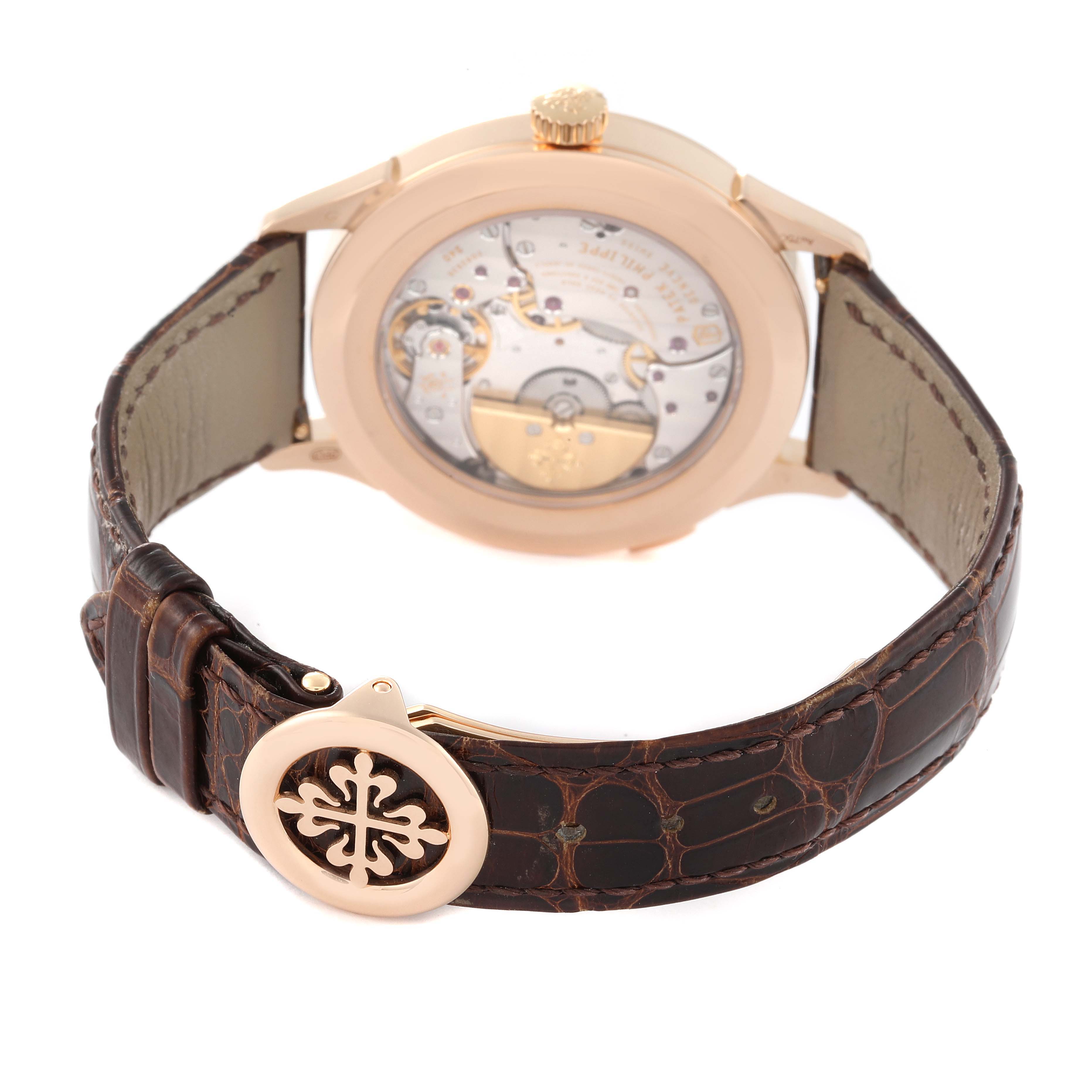 The image shows the back view of a Patek Philippe Complications 5230R Men's Rose Gold Grey Dial 5230R Men's Rose Gold Grey Dial model watch, highlighting its movement and leather strap.