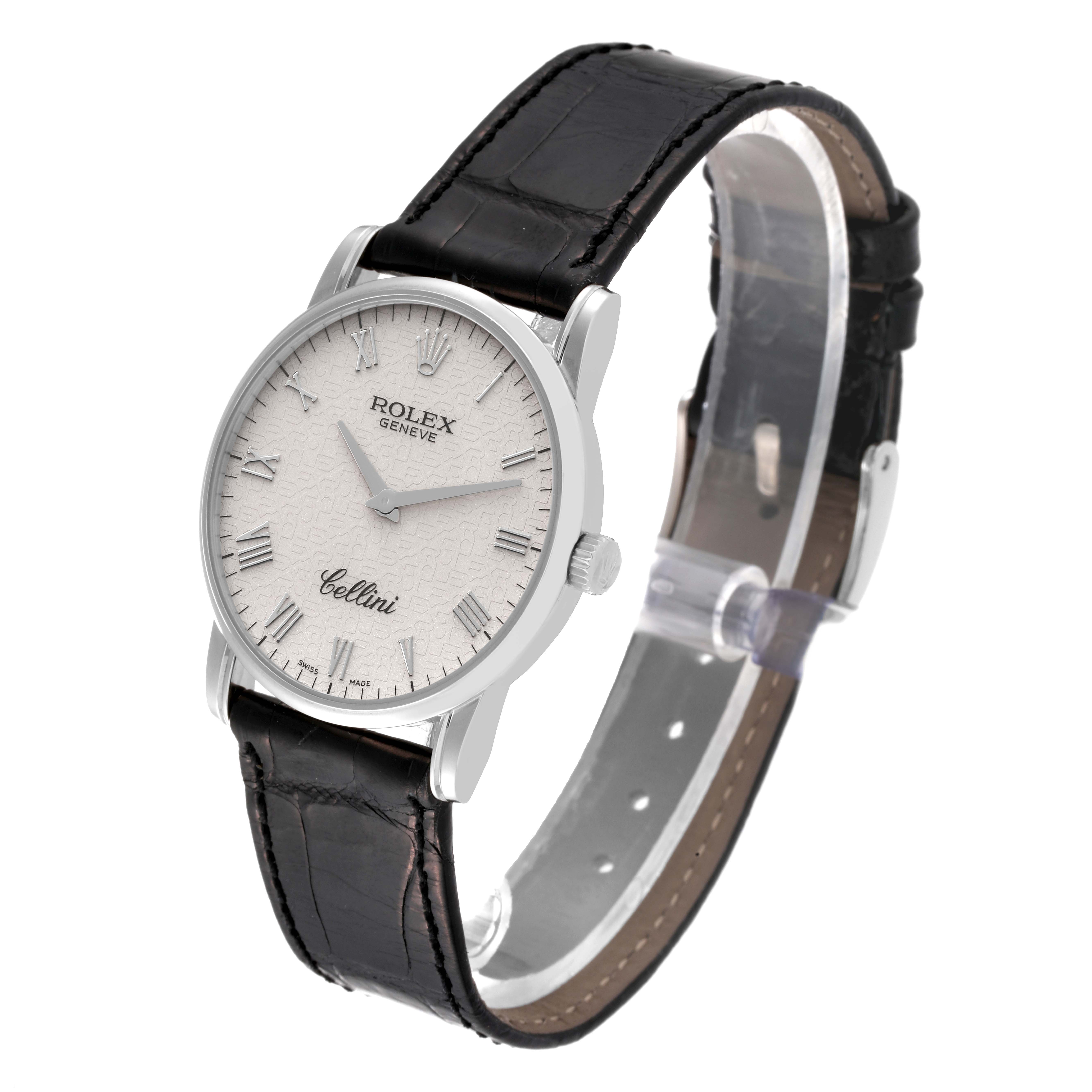 The Rolex Cellini 5116/9 Men's White Gold White Dial 5116/9 Men's White Gold White Dial watch is shown at a slight angle, displaying its white dial, Roman numerals, silver case, and black leather strap.